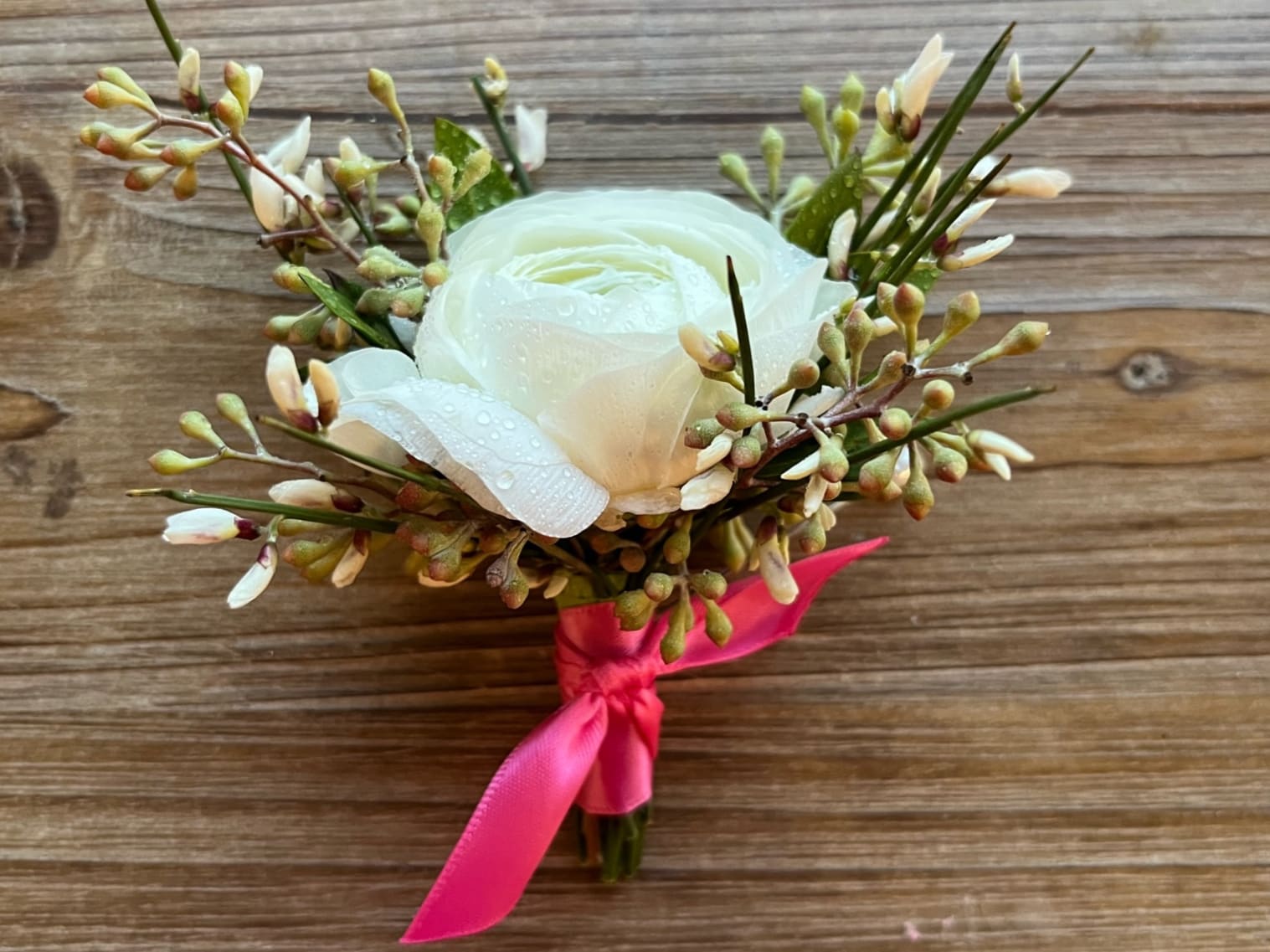 Boutonniere #10 White Ranunculus - White ranunculus boutonniere with a variety of greenery and filler. Please specify ribbon color.
