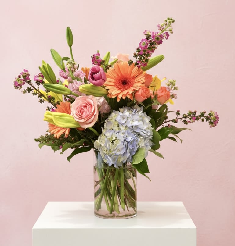 Spring Fling - A Tall Cheerful arrangement with beautiful colors to brighten anyone’s day. Exact flowers will vary 