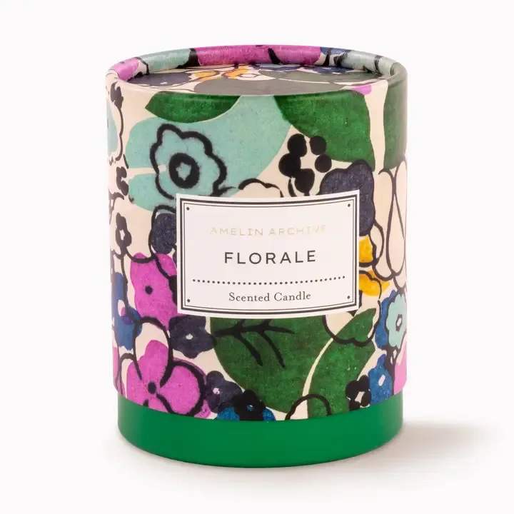 Amelin Archive Floral Candle  - A wild garden in bloom.  The Florale Candle from The Amelin Archive captures the essence of a lush, untamed garden—rose and peony blossoms mingling with fresh herbs, green fig, and soft vanilla. This fresh floral scent is artfully blended to bring our Florale pattern to life through fragrance—delicate yet vibrant, familiar yet modern.  Inspired by vintage apothecary packaging, the Florale Candle arrives in a two-piece paper-wrapped presentation box, making it a truly stunning gift. The intentionally simple cream glass vessel adds understated elegance, designed to complement any home or interior style.  A bestseller and timeless favorite, this candle perfectly reflects The Amelin Archive’s passion for color, pattern, and storytelling through design and scent.  Key Features:  Fragrance notes: rose, peony, green fig, herbs, and vanilla  9 oz. candle in a minimalist cream glass vessel  Inspired by vintage apothecary packaging  Two-piece paper-wrapped box for beautiful gifting  Elegant, artful, and a customer bestseller!   Ideal For:  Design-forward home and lifestyle boutiques  Museum and gallery gift shops  Art and fragrance enthusiasts  Hostess, housewarming, or holiday gifts  Modern interiors and collectors of creative décor  Paired sales with matching trays or journals   