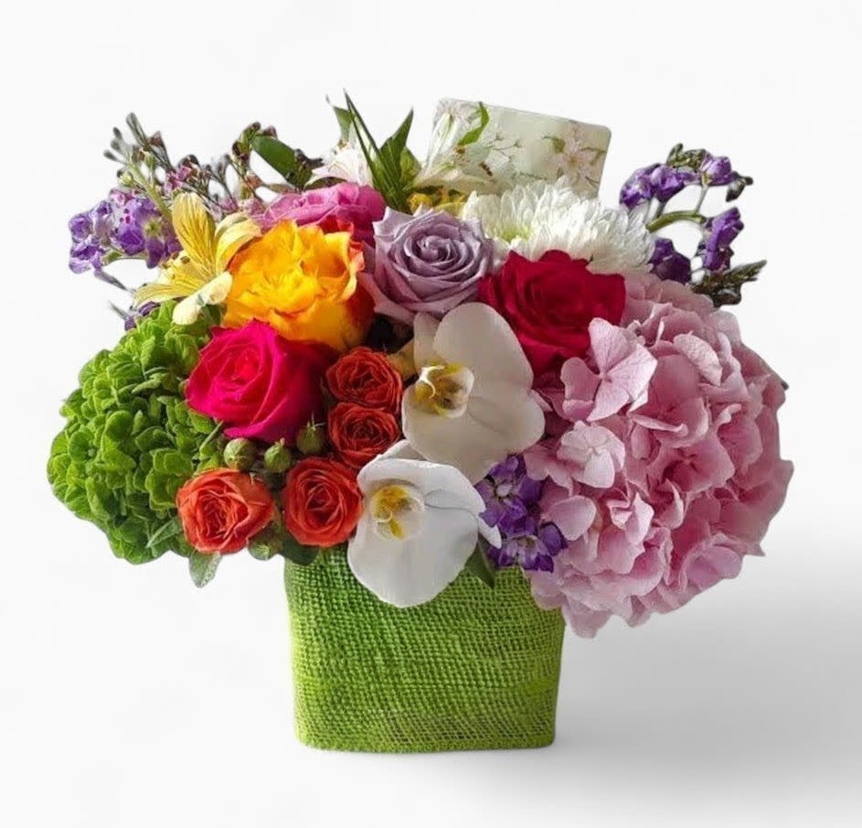 Colorful Blossoms Beauty Bouquet - Send this designer's choice colorful blossoms beauty bouquet today to show them how much you care with it's beautiful mixed orchids and roses arranged in a modern glass cube vase wrapped in pretty soft citrus jute ribbon. Always made unique different and extra special each and every time. Please visit my beautiful gallery to see my latest designs that I have created for my online customers. Send them happiness today.