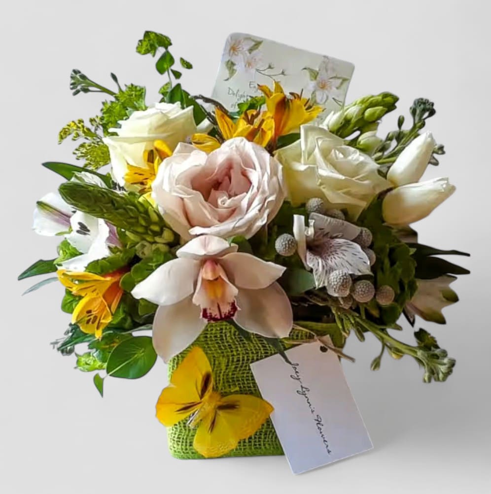 Citrus Rose And Orchids Blossoms Beauty Designer's Choice - Perfect for every occasion. Send this beauty today to show them how much you care with it's beautiful, citrus color blossoms of that day roses orchids and more arranged in a modern glass cube vase wrapped in citrus jute ribbon. All fresh flower bouquets that leave my flower studio are works of art, made with lots of care. Please visit my beautiful gallery to see my most recent designs that I have created for my online customers. Send them a special bouquet to make them smile today. 