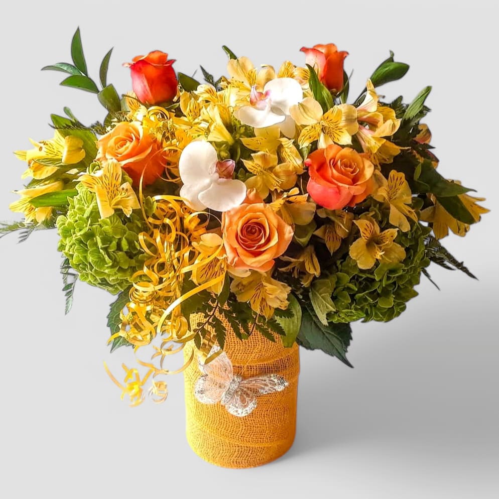 Sunny Happy Birthday Designer's Choice - Send this beauty today to make them overjoyed with it's fall vibe flowers arranged in a tall modern glass cylinder vase wrapped in pretty yellow jute ribbon. Perfect to send today for every reason. Send happiness.