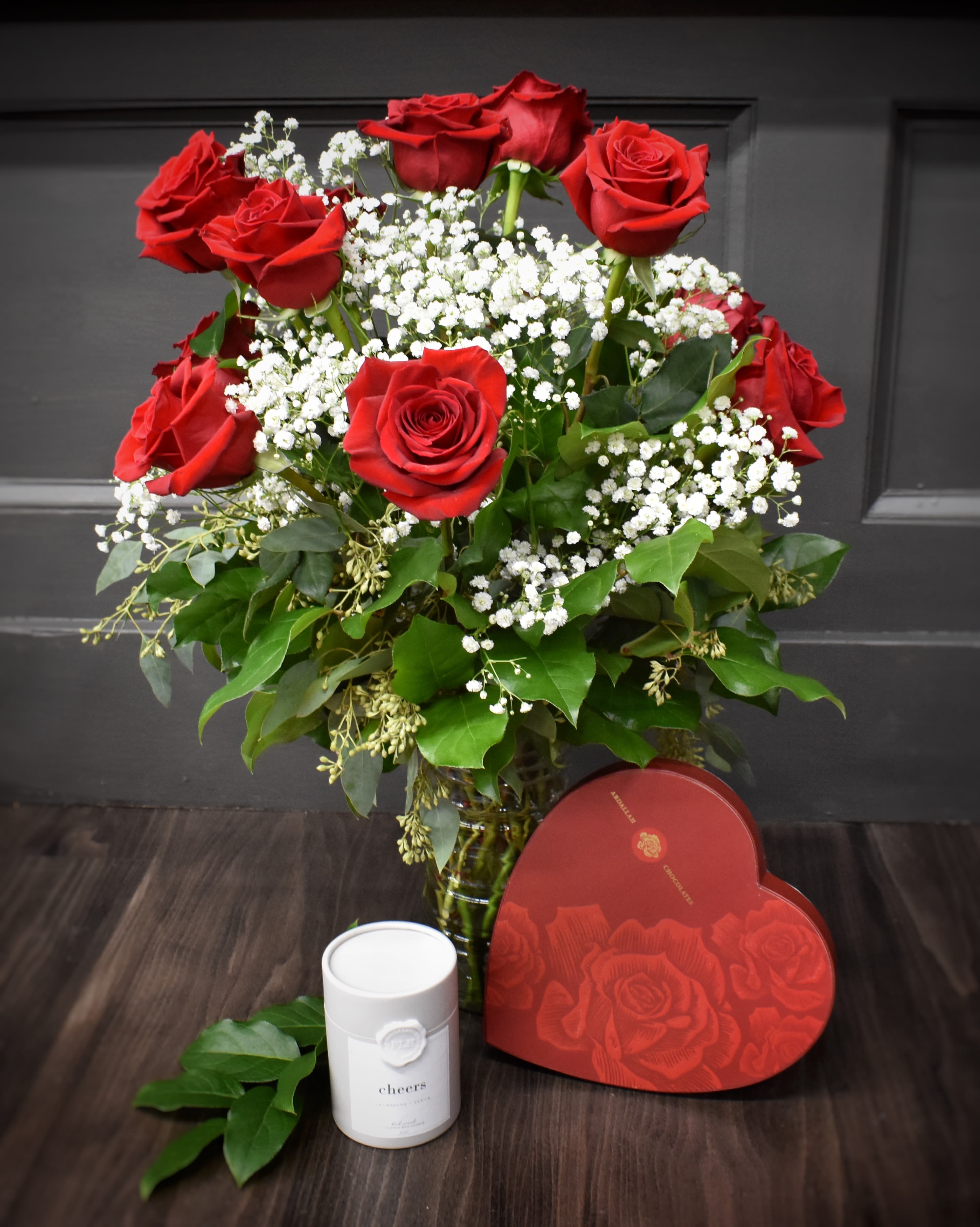 All In - We've made valentine shopping easy for you! One dozen red roses, a beautiful valentine candle,   one pound heart box of assorted chocolates.