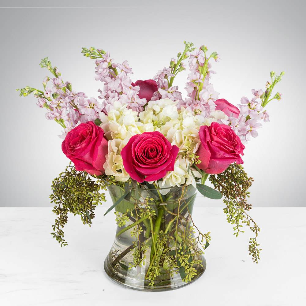 Hot Stuff - This arrangement contains white hydrangea, pink roses, pink stock, &amp; seeded eucalyptus. Great gift for Valentine's Day, Birthday New Romance, or Just Because. APPROXIMATE DIMENSIONS: 13"H X 10" W
