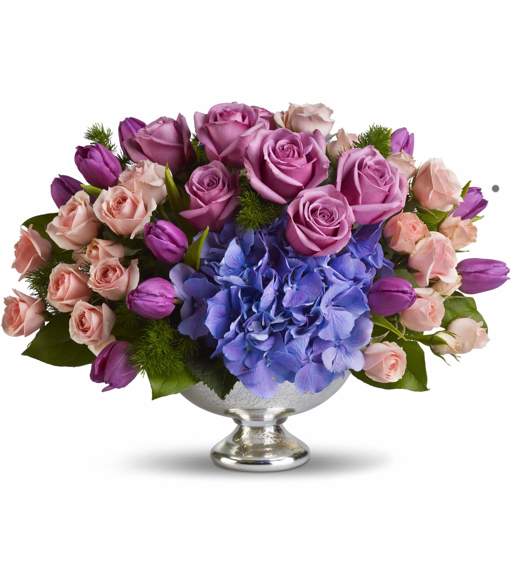 Purple Elegance Centerpiece  - A masterpiece in purple. This lush, lavender array mixes beautiful blue hydrangea with happy purple tulips and luxurious lavender and pink roses. Presented in an elegant Mercury Glass Bowl, it's an exquisite choice for any important event, from weddings to showers.  Purple tulips, blue hydrangea, lavender and pink roses are mixed with delicate ming fern and rich green salal in a magnificent Mercury Glass Bowl.  Approximately 17" W x 12 1/2" H  Orientation: All-Around      As Shown : T197-1A  