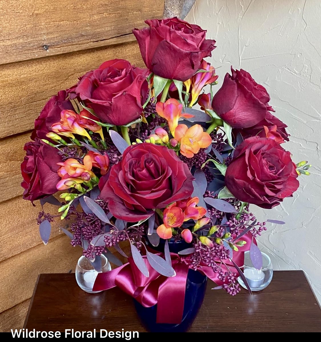 Burgundy Roses - Beautifully designed burgundy roses accented with designer selected accent flowers, greens and vase!  