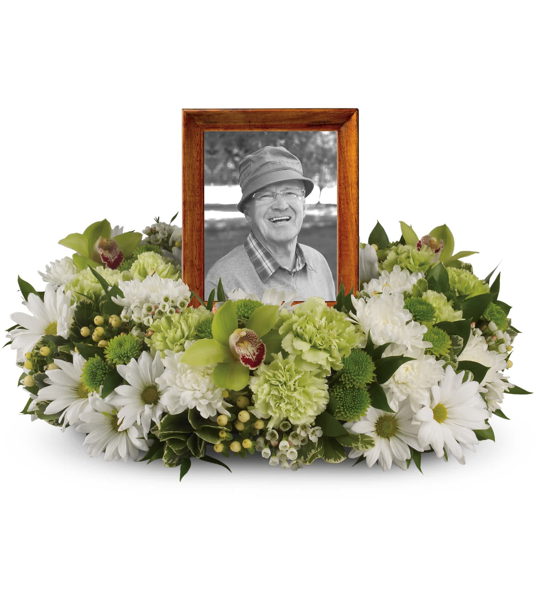 Garden Wreath - An exquisite round wreath with blooms inspired by the lasting impressions a loved one makes on our lives. Surround a treasured photograph, poem or other dear memento with sweet, green carnations, white and green chrysanthemums and the special beauty of green cymbidium orchids.  This luxurious wreath includes flowers such as carnations, chrysanthemums, silky green cymbidium orchid blossoms and variegated greenery. Please note: Arrangement does not include picture frame.  Approximately 20" W x 14" H  Orientation: One-Sided      As Shown : T255-1A  