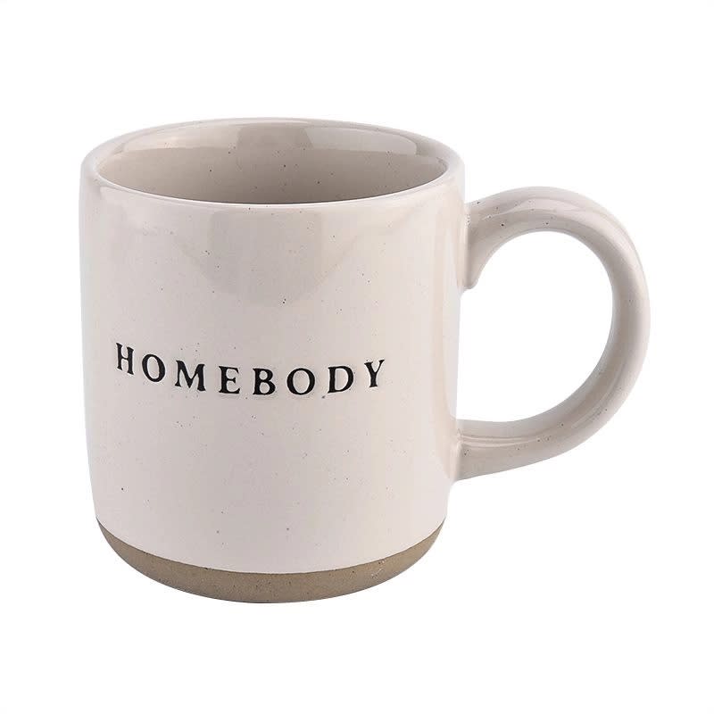 SWD  - Homebody Coffee Mug   - • 14oz Stoneware Style Mug • Size: 3.31 x 3.93" (5.19" w/handle) • Original Design: Homebody • Design on Both Sides of Mug • Cream With Black Lettering • Speckled Design with Natural Bottom Details (Each is Perfectly Unique) • Designed in the USA, Imported • UPC: 00811119034080 | Style No. CM064  CARE:   • Microwave and Dishwasher Safe • Wash Before Use and Avoid Abrasive Cloths When Cleaning • Use Caution When Removing From Microwave