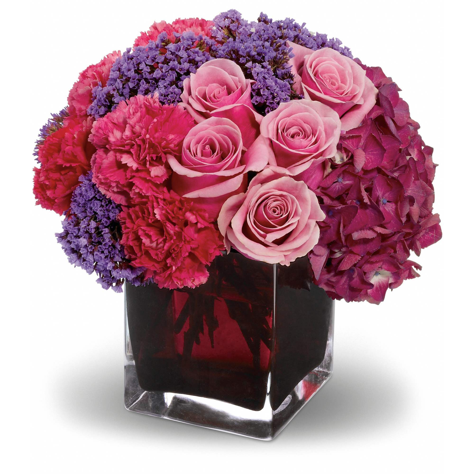 Enchanted Journey - Romance that stands all the tests of time is like an enchanted journey. This beautiful arrangement is a wonderful way to celebrate that love.  Gorgeous dark pink hydrangea, pink roses and carnations, plus lavender statice are lovingly arranged in an exclusive plum-colored cube vase.  Approximately 9" W x 9" H  Orientation: All-Around  As Shown : T10-2A Deluxe : T10-2B Premium : T10-2C