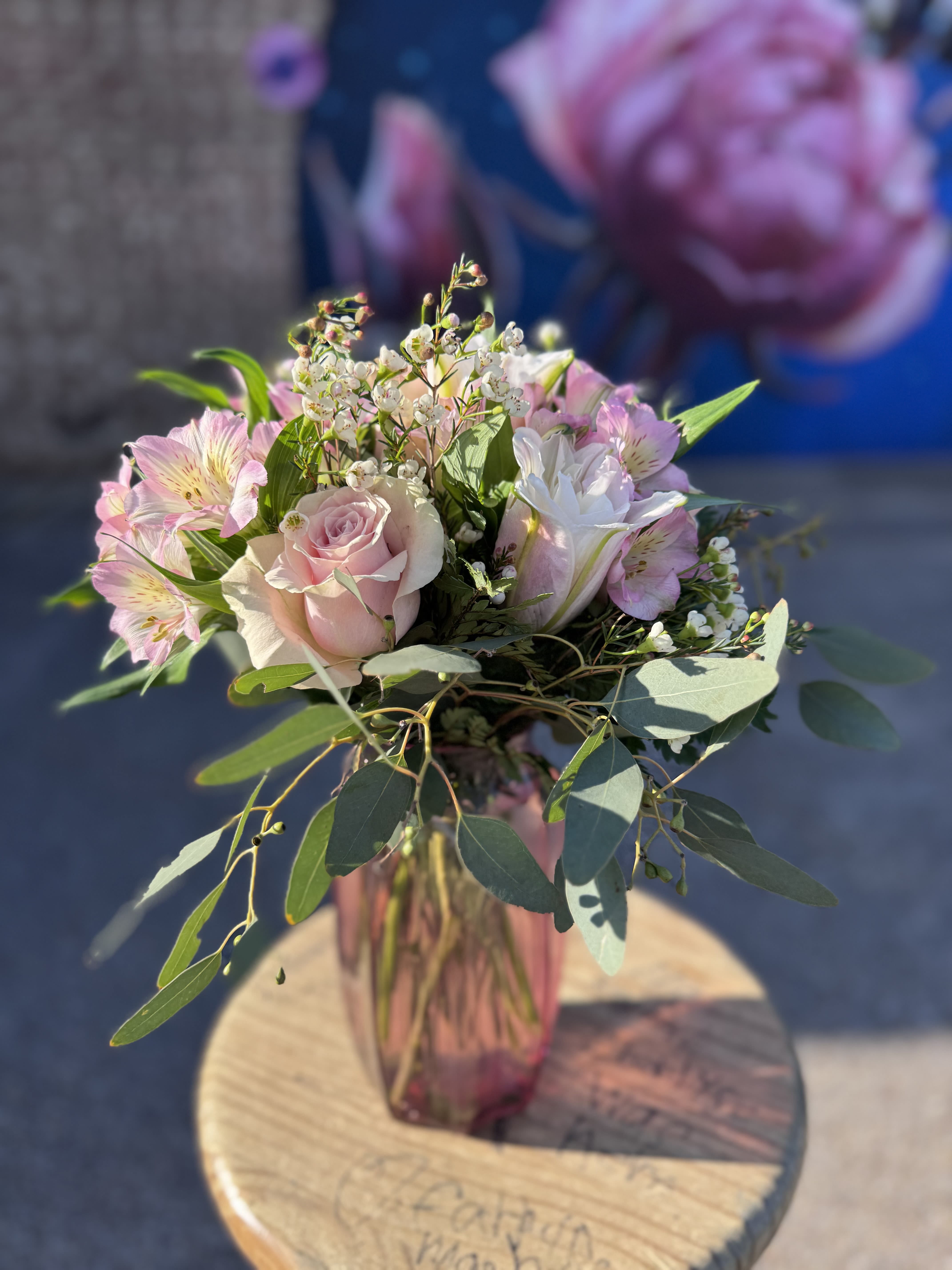 Cute Pie - Sweet, stylish, and effortlessly romantic—Cutie Pie is designed to charm from the moment it arrives. Featuring soft pink roses paired with delicate white and pink blooms, this arrangement is accented with airy wax flower and fresh seeded eucalyptus for a light, graceful finish.  Designed in a mauve glass vase with clean lines, Cutie Pie is perfect for Valentine’s Day when you want something thoughtful, elegant, and undeniably adorable.