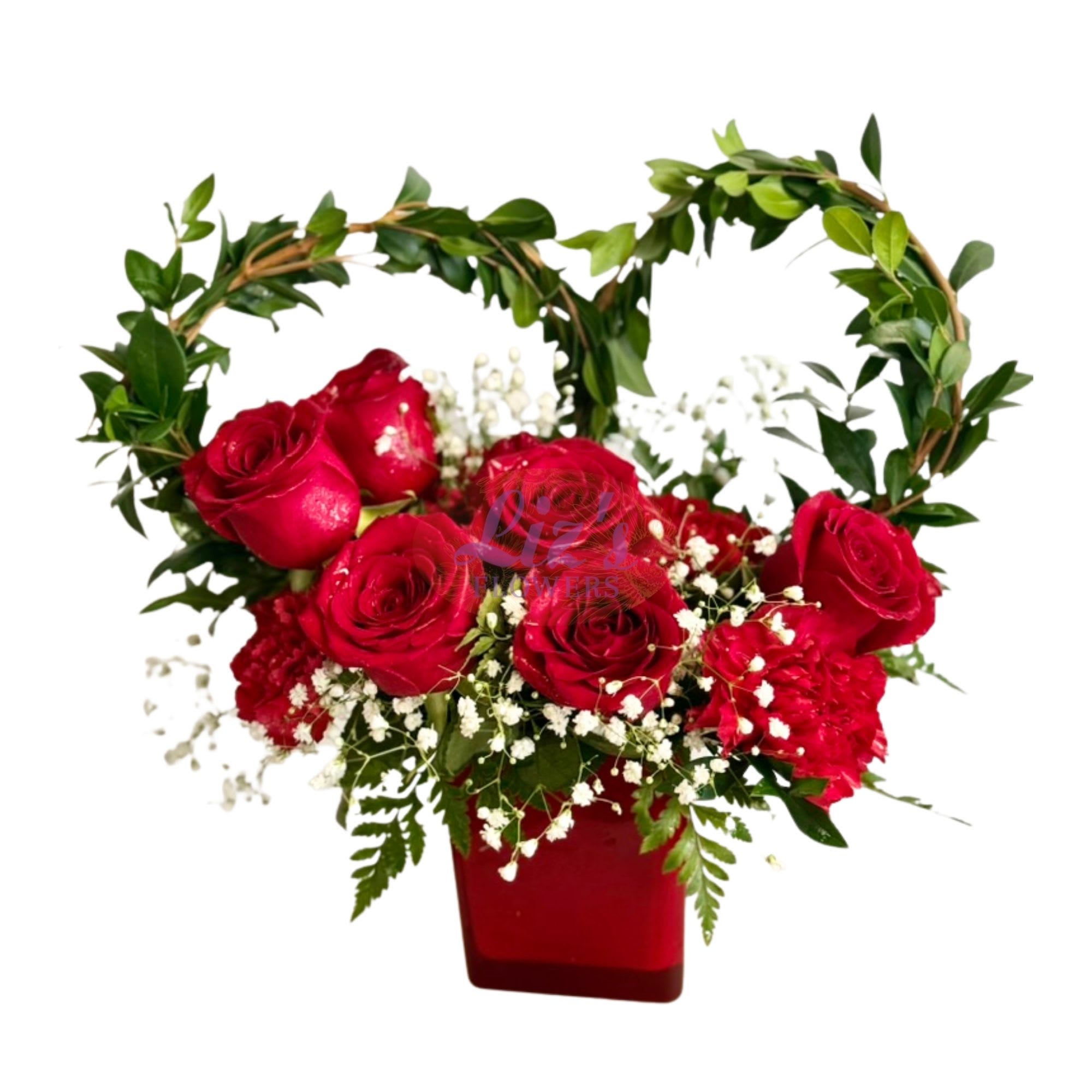 Heart Of Roses - Features red roses and carnations, accented with baby's breath, and crowned with heart-shaped vine.