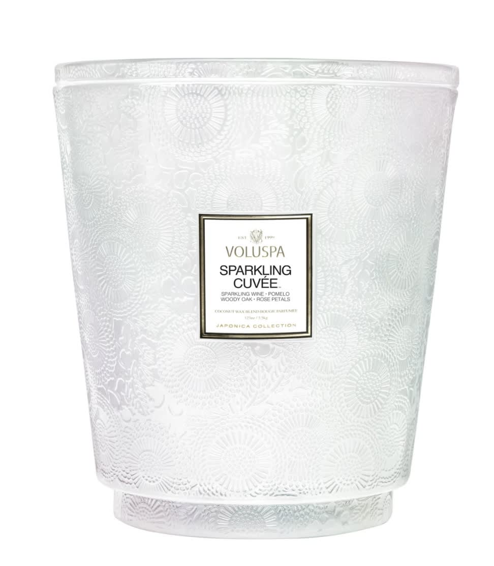 Voluspa Hearth Candle - Sparkling Cuvee - Pop a bottle of Voluspa’s finest blend, it’s time to celebrate! A mix of beautiful aromatic complexity, Sparkling Cuvée opens with vivacious fruit tones of Sparkling Wine, Pomelo and Red Currant.   Voluspa's unique coconut wax blend is hand-poured into a 123 oz. embossed glass vessel and topped with a matching lid that keeps the candle dust-free when not in use. Our five wicks allow you to enjoy fragrance throw for 250 hours. Our candles are hand-poured in the United States and feature our proprietary, clean-burning coconut wax blend and 100% natural wicks. Our products are free of phthalates, pesticides, parabens and sulfates and are never tested on animals. Up-cycle this best seller into a keepsake after the last burn.