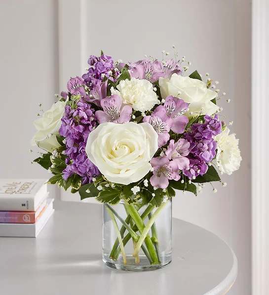 Lovely Lavender Bouquet - Lovely memories are made with thoughtful gifts for the ones we care about. Our charming lavender flower bouquet is loosely gathered with a medley of lavender &amp; white blooms. Hand-designed inside a clear cylinder vase with cascading greenery all around, it’s a wonderful way to express the sentiments you have inside your heart.