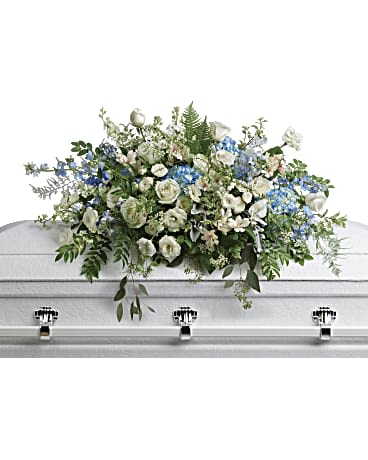 Tender Remembrance Casket Spray - As soft and delicate as a tender remembrance, this stunning spray of sky blue hydrangea and pure white roses brings a fresh, natural beauty to the casket. This stunning spray includes blue hydrangea, white roses, white spray roses, white alstroemeria, white lisianthus, blue delphinium, white larkspur, white stock, white waxflower, dusty miller, huckleberry, asparagus plumosus, pitta negra, lily grass, dagger fern, and lemon leaf. Approximately 36" W x 24" H