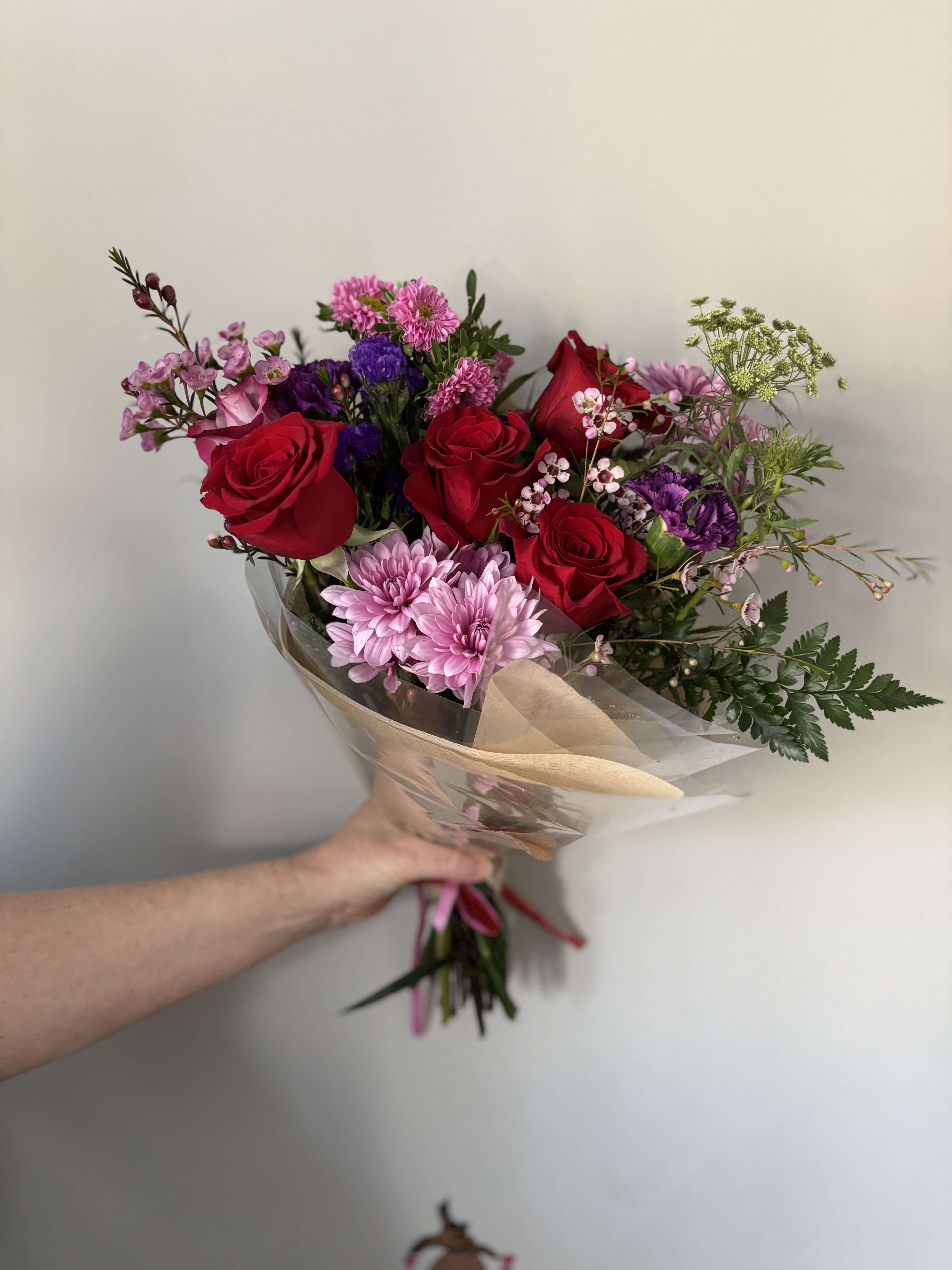 Standard, Designer's Choice Valentine's Bouquet  - Show your sweetheart some love with our standard sized Valentine's Bouquet. This selection includes at least 5 gorgeous roses along with a mix of seasonal blooms and textures. Please note, the colors and flowers may vary as this is a designer's choice selection.  * does not include a vase * For pickup only. 