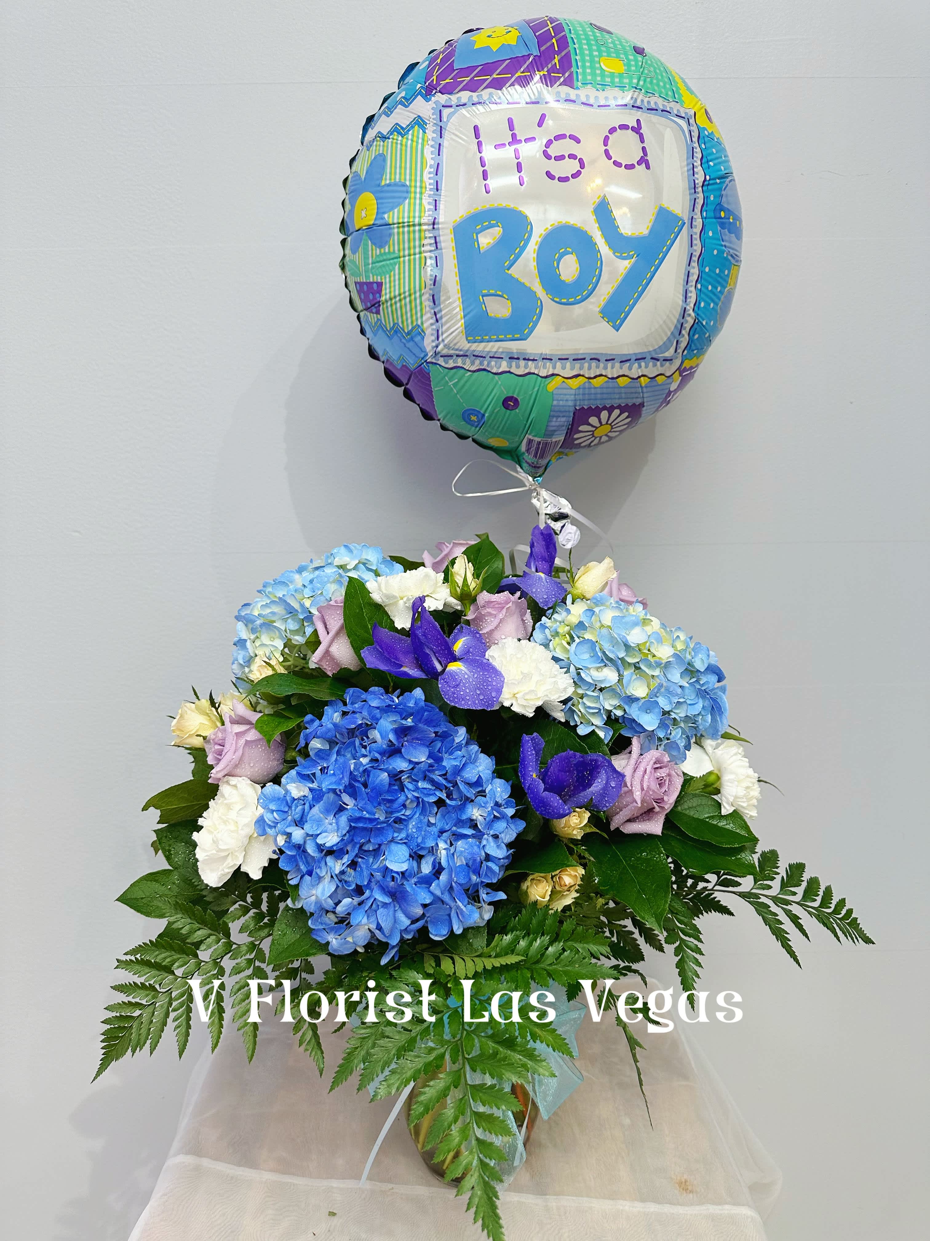 its a boy  - A beautiful mix of Lavender roses, light blue hydrangeas, iris, white carnations, and white spray roses in a vase. great for gender reveal parties and baby showers. Our florists select the freshest flowers available, so colors and varieties may vary due to local availability.