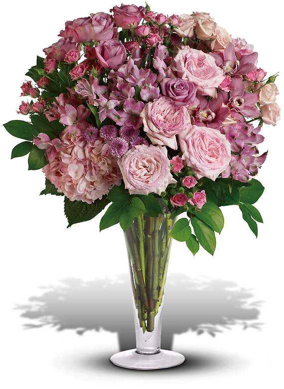 A LA MODE BOUQUET WITH LONG STEMMED ROSES - Go all out for love with this breathtaking bouquet of pink orchids, pink roses, lavender roses and other fabulous favorites in a stylish flared glass vase. She will definitely be bowled over.  This exquisite bouquet includes pink orchids, pink hydrangea, pink roses, lavender roses, pink spray roses, light pink spray roses, pink alstroemeria and lavender button spray chrysanthemums accented with assorted greenery.