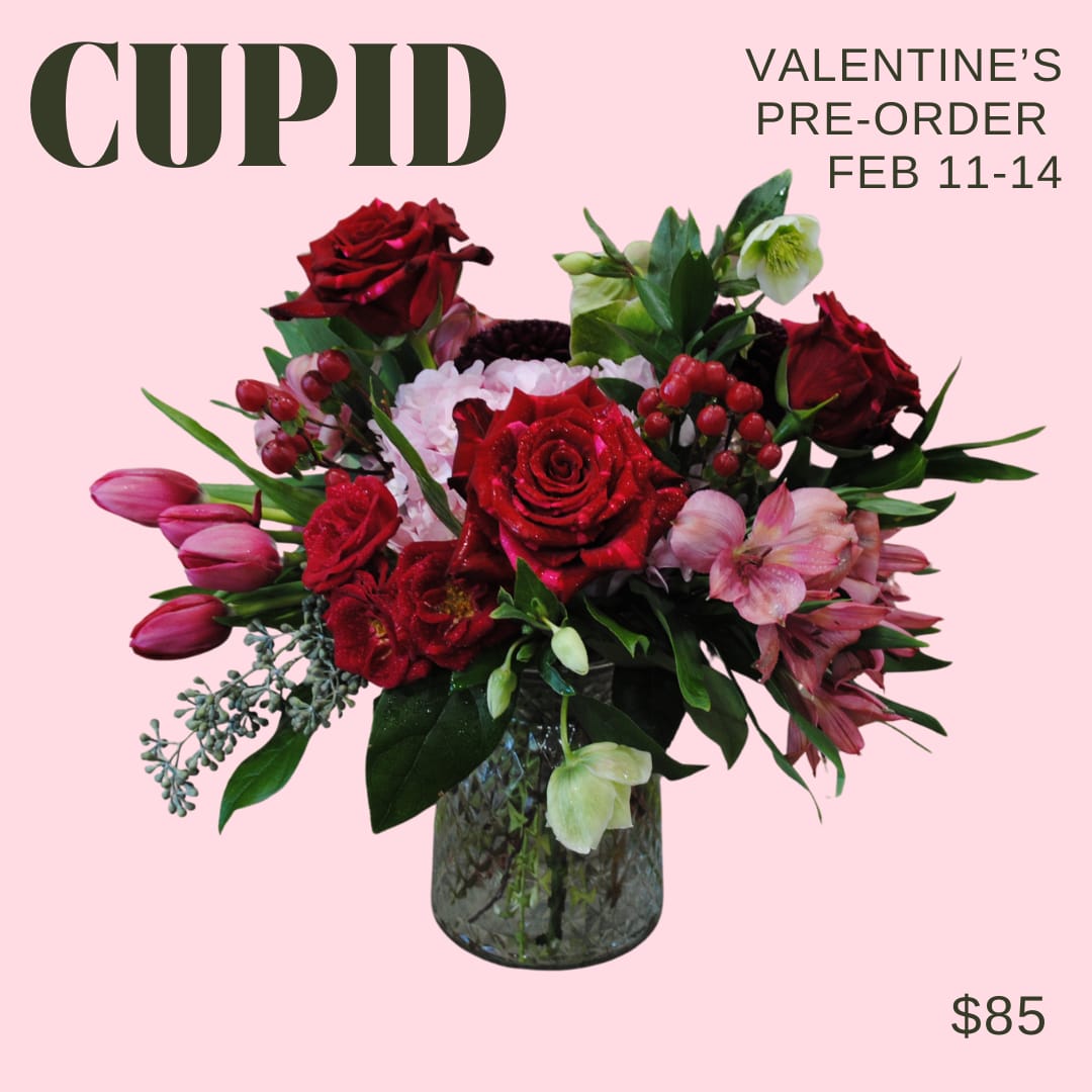 Cupid - Red - A primarily red toned arrangement in a glass vase!   Deluxe and premium price points will have additional blooms added
