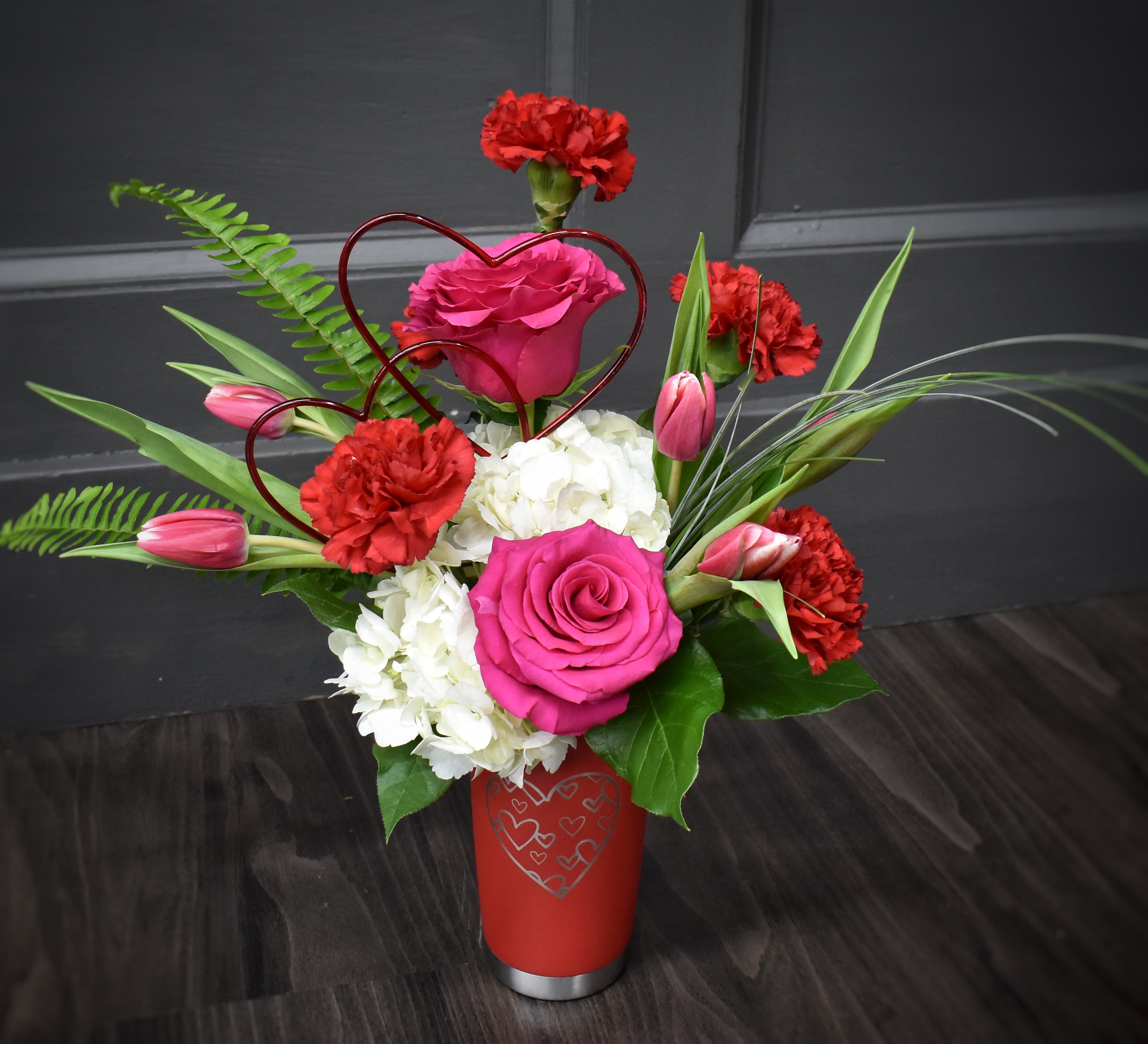 Premium Perfect Together  Thermal Mug Bouquet - Don't need another vase taking up space in the basement? How about an insulated mug you can use again and again as a reminder of the flowers you received from your partner on Valentine's day! This tumbler is exploding with blooms including a fluffy hydrangea, tulips, carnations, roses and a heart pick. 