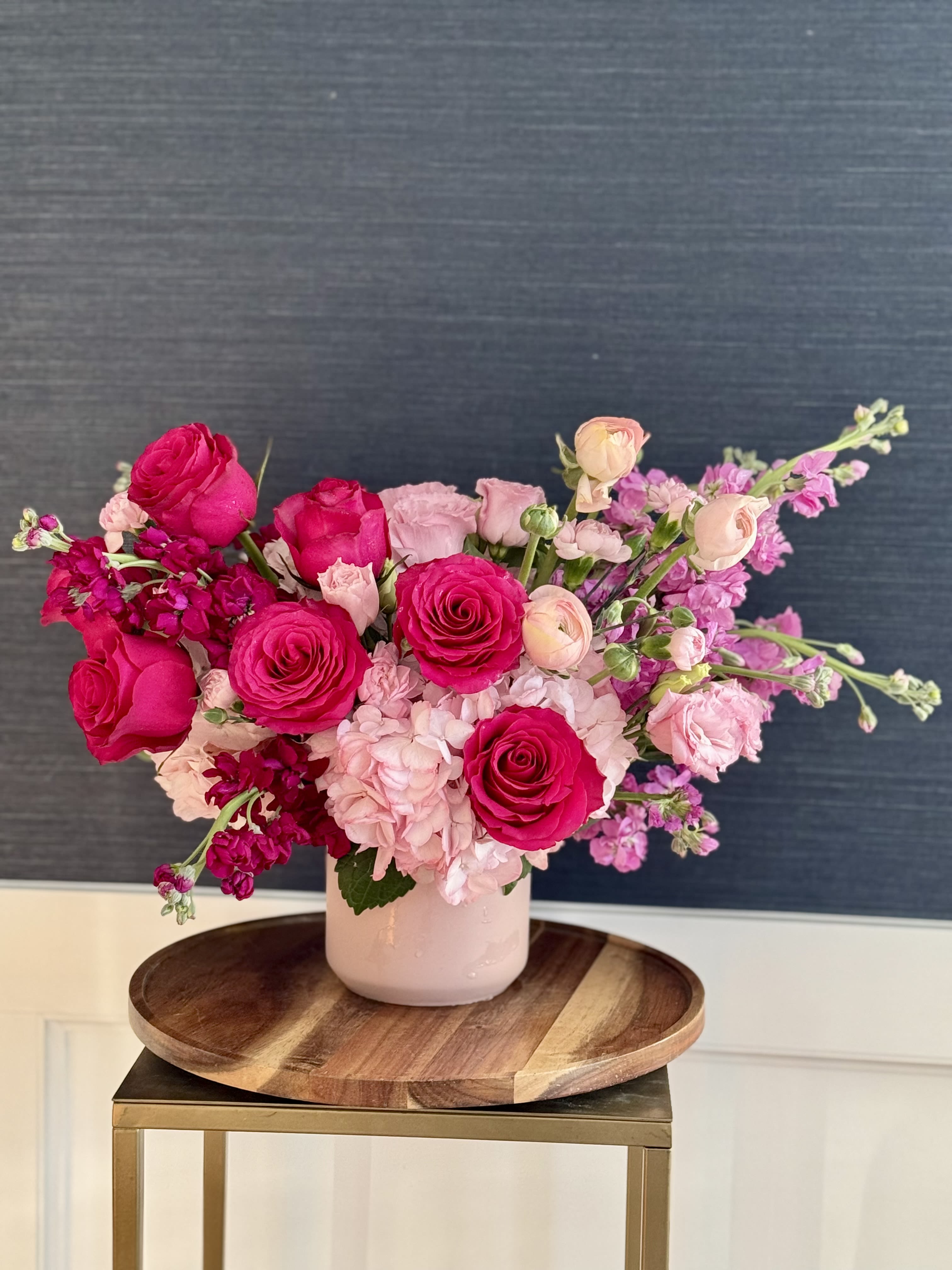 Lovestruck - A mixed flower bouquet with reds and pinks in a pink vase.