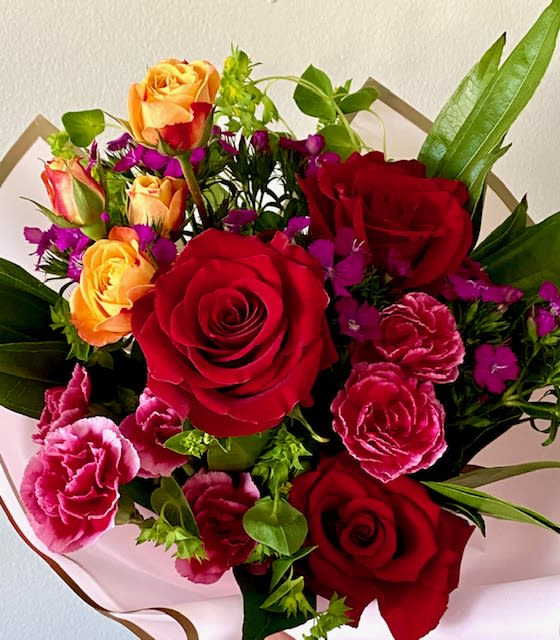 Valentine's Day Designer's Choice Wrap: Reds &amp; Brights Wrap - Vivid assortment of premium blooms in red, fuchsia and tangerine nestled in our signaure wrap and bow. 