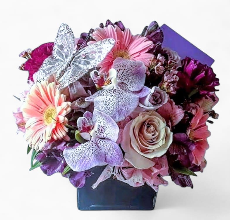 Lavender In Black Designer's Choice - Roses orchids and more arranged in a black modern glass cube style vase. Perfect to send for every reason today. All of my designs are always made extra special and unique each and every time. Send them happiness.