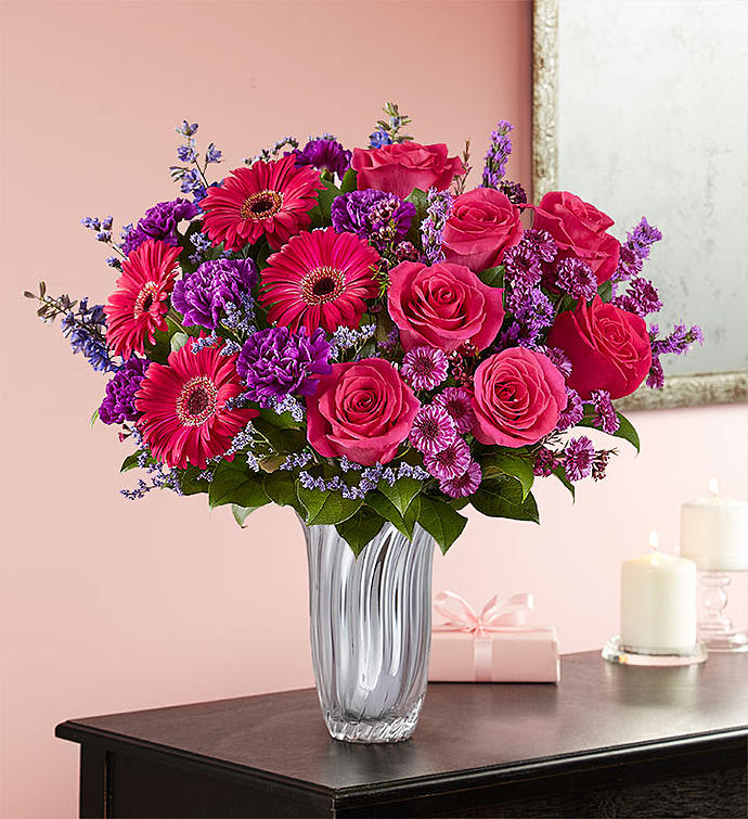 BECAUSE YOU'RE MINE - For your one and only, a gorgeous gathering that says, “I’m glad you’re mine.” Our show-stopping arrangement of vibrant pinks and passionate purples in a truly unique asymmetrical design, it arrives in our sparkling Silver Radiance Vase for a spectacular display of your affection. A bouquet like this will leave no doubt as to just how you feel.