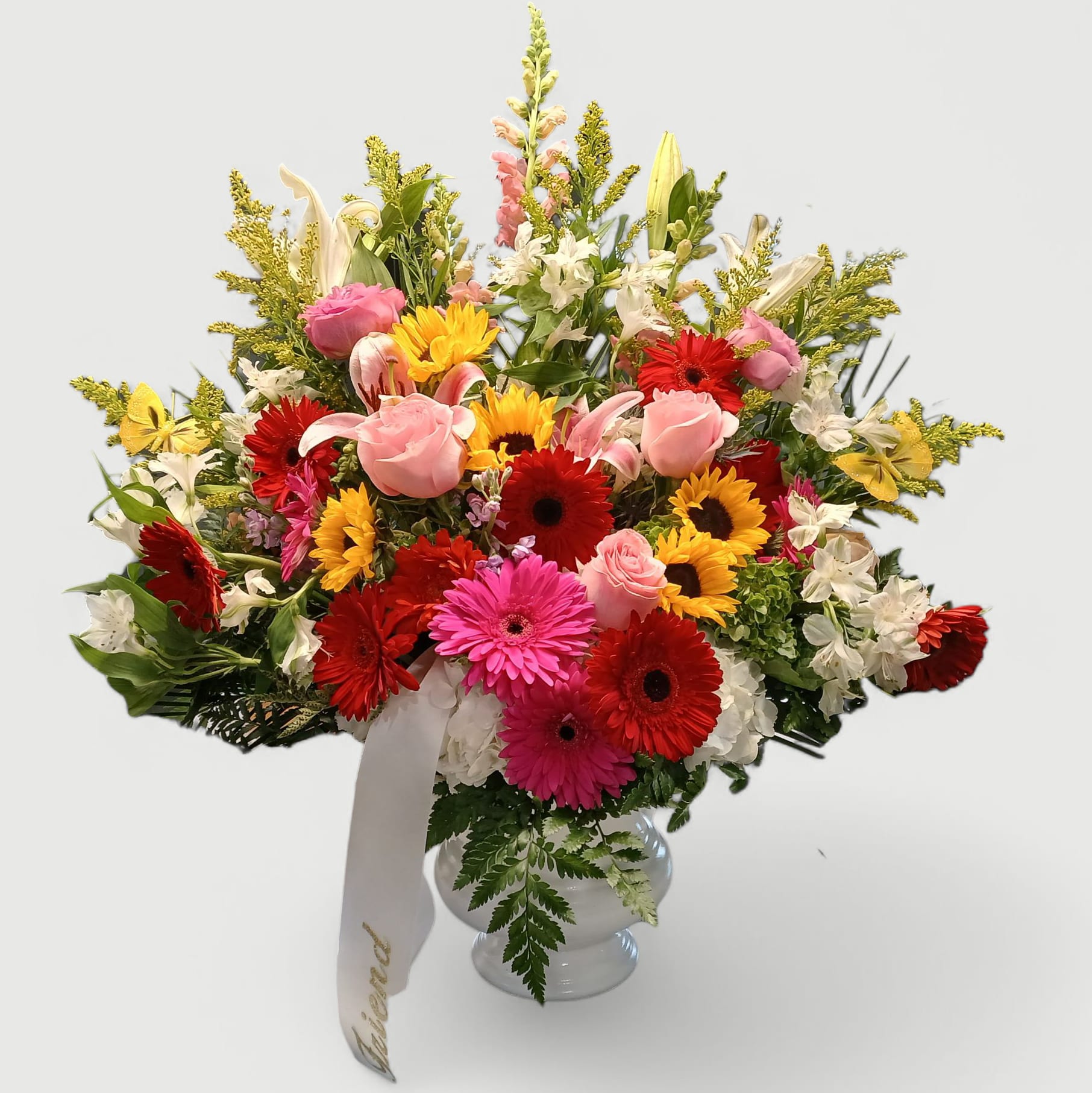 With Our Sincere Condolences Bouquet - Beautiful mixed uplifting blossoms bouquet of roses daisies hydrangeas lilies stock and so much more arranged in a lovely white vessel. Perfect to send today to the service to help them celebrate a life well lived. Send today to show them your deepest condolences.