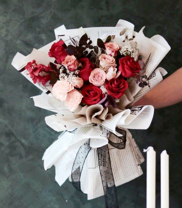 Valentine's Day - Roses Deluxe Hand Wrapped - One Dozen beautiful red or pink roses beautifully and uniquely paper wrapped in our signature wrapping style.  No vase included.  Send her something that's as unique as she is!  Please note, due to the high demand during the Valentine’s season, substitutions with a similar premium rose variety may be necessary to ensure timely delivery. Experience the timeless beauty of these extraordinary roses and make this Valentine’s Day unforgettable.