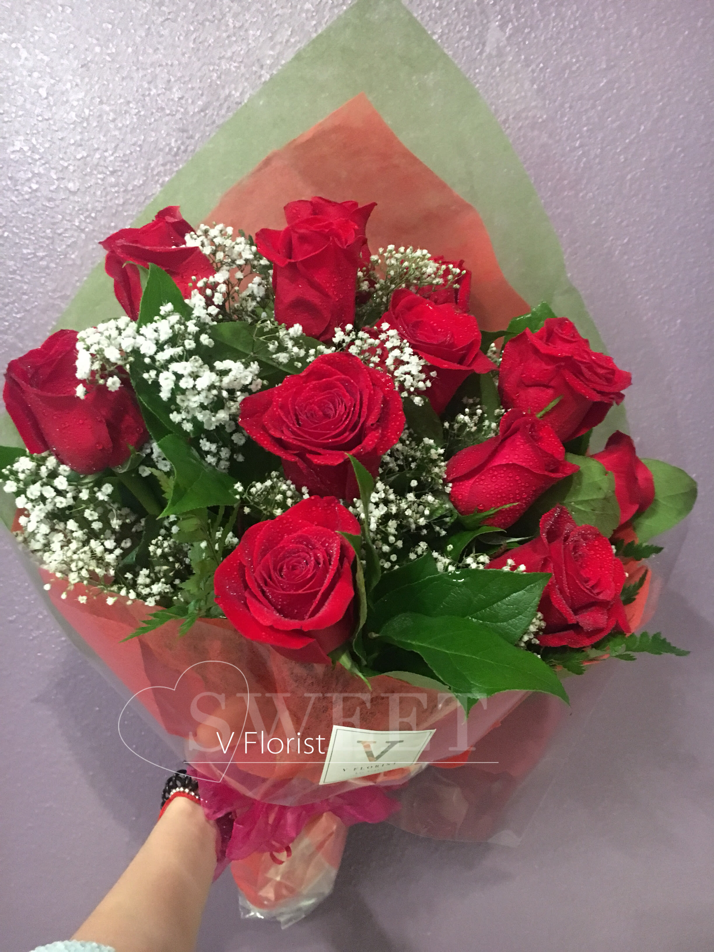 Simple Wrapped Red Roses Bouquet - 12 red roses wrapped in a hand-hold bouquet with babies' breathe and greens. Best for surprises, date night, and celebrations. 
