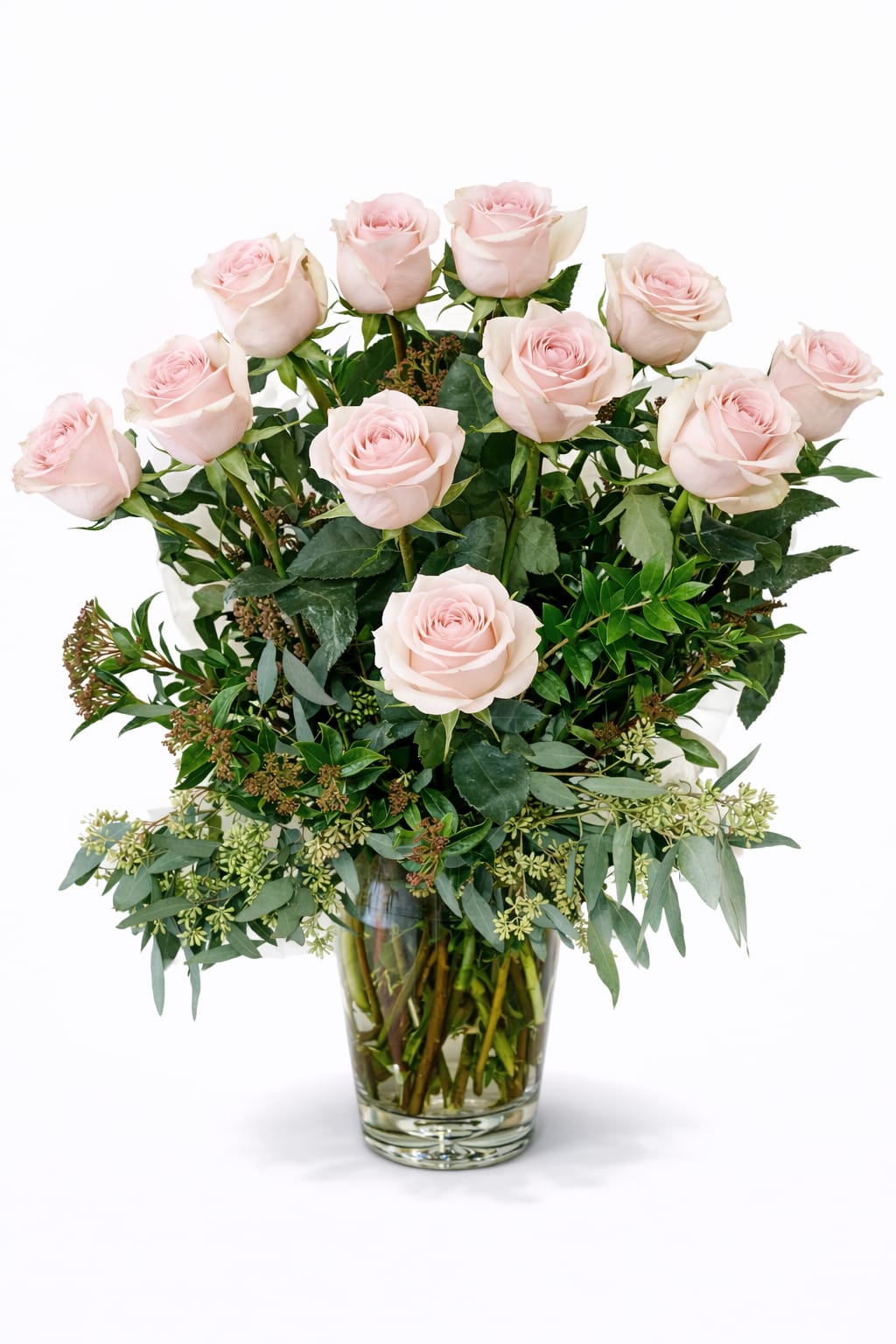 Pink Mondrian Bush - Twelve beautiful big headed long stemmed soft pink roses arranged in a bed of lush greenery.  Designed in a tall glass vase