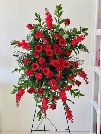 FOREVER MISSING YOU standing spray. - Celebrate the brilliant life of a lost loved one with a standing spray that truly exhibits their vibrant spirit. The Forever Missing You standing spray showcases Gerbera, daisies, carnations, and roses in dazzling reds that radiantly contrast with the luscious myrtle and ivy; giving it the power to ease the minds and comfort the souls of those who are grieving. The Forever Missing You standing spray adds warmth to any funeral service, memorial, or wake.  COLOR CAN BE CUSTOMIZED TO YOUR PREFERENCE.  Picture is a DELUXE.    STANDARD: THREE DOZEN ROSES DELUXE: FOUR DOZEN ROSES PREMIUM: FIVE DOZEN ROSES   Colors available: White, Yellow, Pink, Lavender.  Design is one single color,  please state in the special instructions if you wish to change the color of the flowers.   (Blue is not available for this arrangement) ALSO INCLUDES A COMPLIMENTARY GOLDEN CARD WITH ENVELOPE, PLEASE SEND CARD MESSAGE WITH THE ORDER.