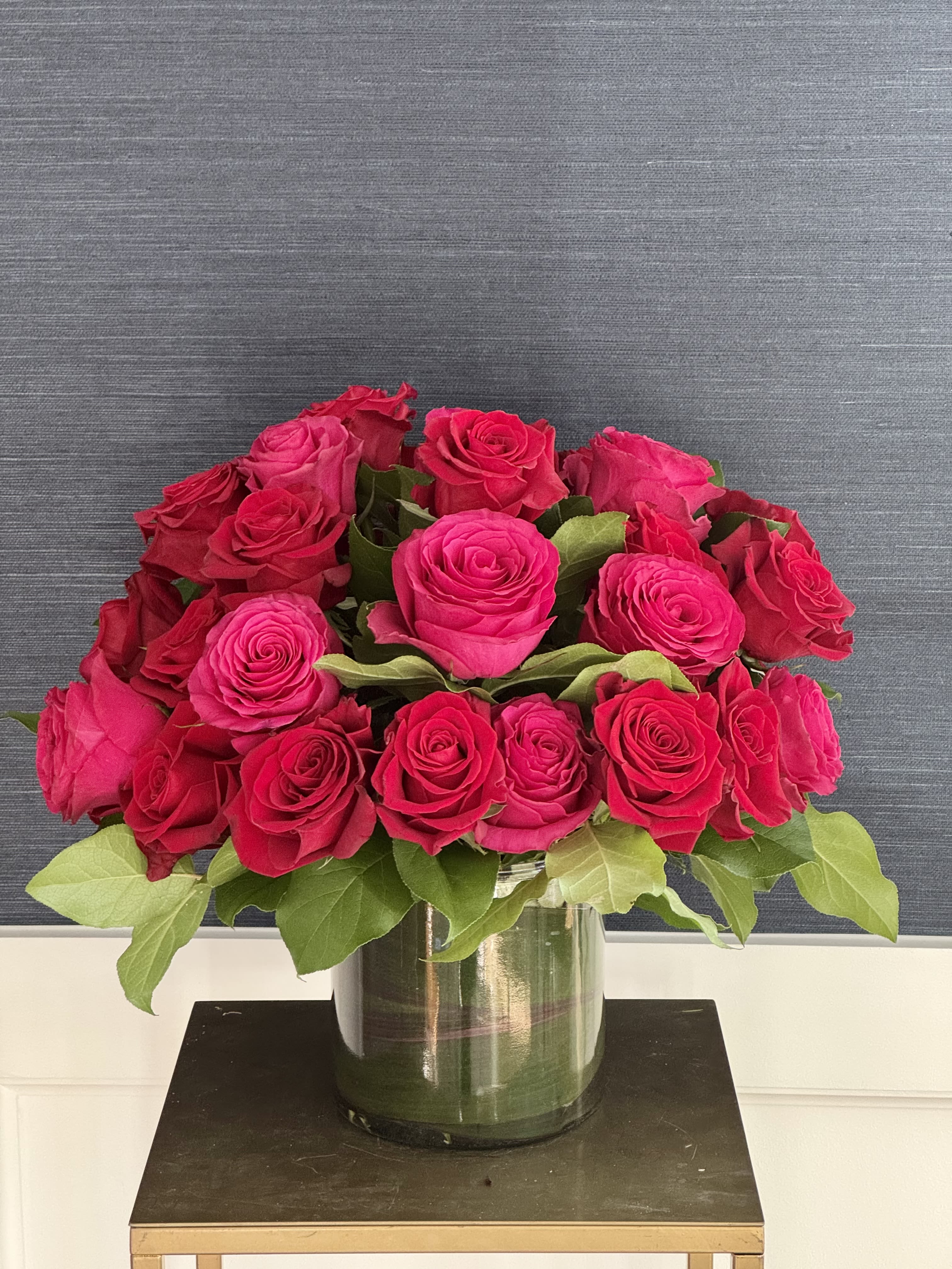 Forever Mine - 36 premium red and magenta roses arranged in a vase with greenery.