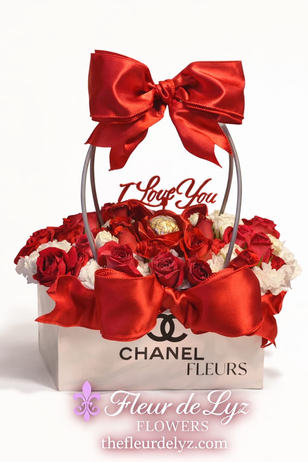 Amour Luxe - Amour Luxe is a timeless Valentines Day arrangement designed to make hearts melt. Featuring a romantic blend of rich red and soft white roses, this elegant design is finished with luxurious satin bows and charming Valentine accents. A Stunning choice for expressing love and appreciation and unforgettable romance. Limited quantities available. Order early to secure this exclusive Valentine's Day design