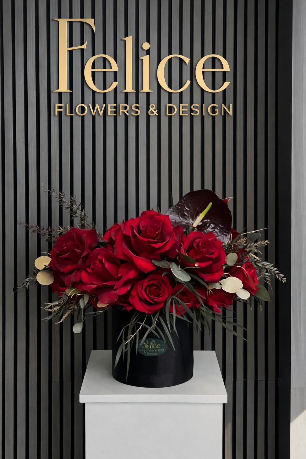 Red Rose &amp; Anthurium Modern Arrangement - A bold and modern floral arrangement featuring premium red roses accented with dramatic anthurium, textured foliage, and natural elements designed in a sleek black hatbox. Perfect for Valentine’s Day, anniversaries, birthdays, and statement romantic gifting. Handcrafted by our Los Angeles florist using premium flowers and available for same-day flower delivery.