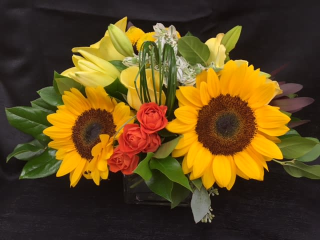 HAPPY FACE - Sunflowers, billy balls, lillys and roses in 5" cube, perfect for bringing sunshine to someone you care about! 