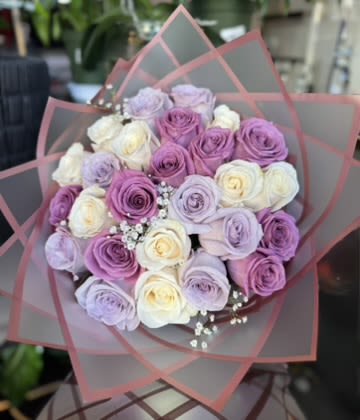 Lavender Elegance Bouquet - Refined and captivating, the Lavender Elegance Bouquet embodies modern sophistication. A graceful blend of premium lavender, lilac, and ivory roses creates a soft yet striking composition, symbolizing elegance and tranquility. Accented with delicate baby’s breath and wrapped in sleek, layered matte paper, this bouquet offers a contemporary aesthetic with timeless allure. Perfect for refined gifting or upscale events, it’s a true statement of effortless luxury and style.