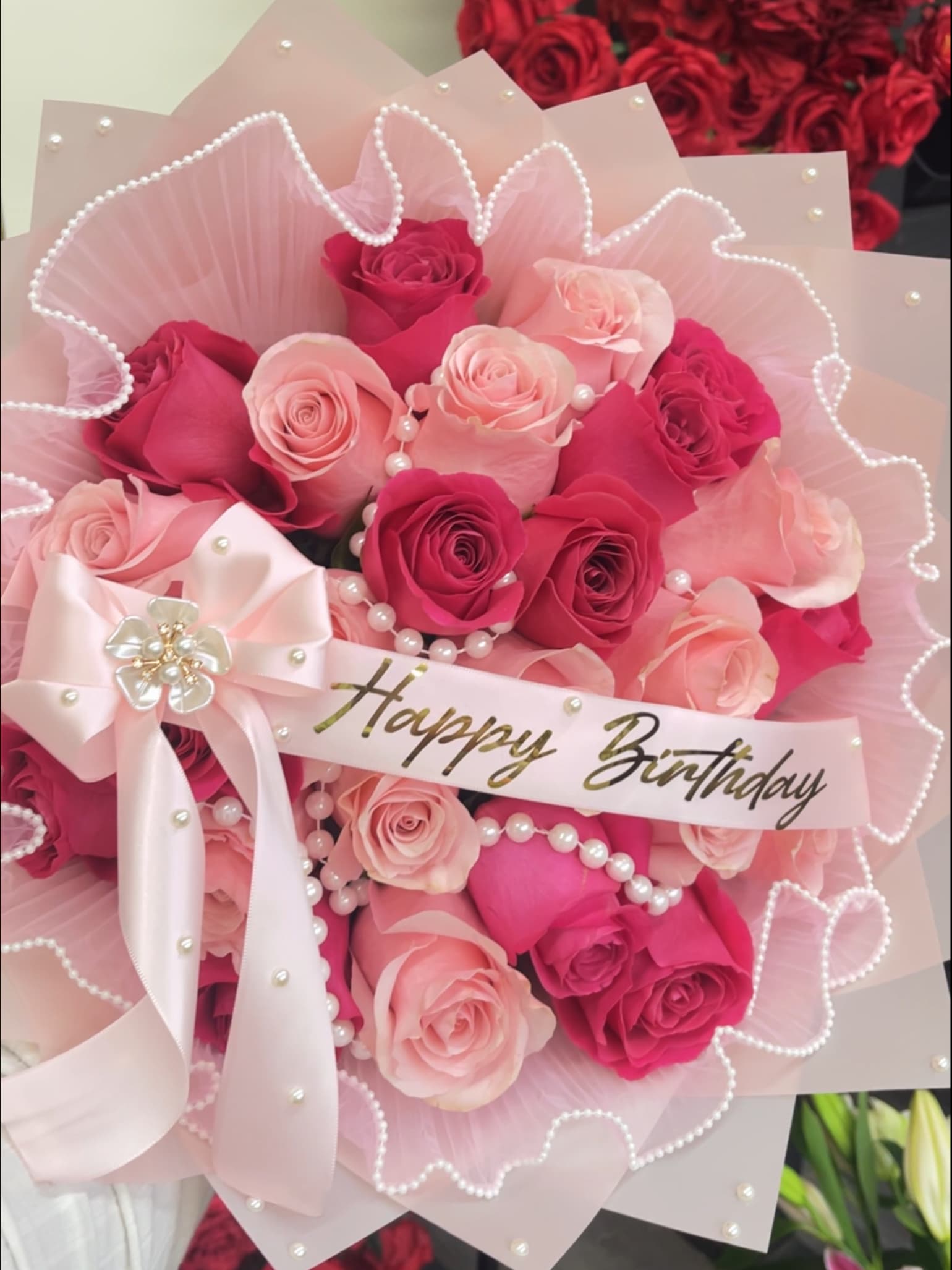 Blushing Pearl Bouquet - A stunning combination of hot pink and light pink roses, beautifully arranged with a delicate pearl mesh encircling the blooms. Finished with a personalized ribbon, this elegant bouquet exudes charm and sophistication, making it perfect for celebrating love and special moments.  **Please add the following in Special Instructions: ** 1. Personalized Message on Banner 