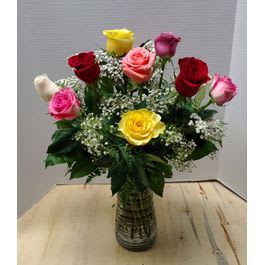 Roseanne - Assorted colored dozen roses with filler and greenery, artfully placed in a clear glass vase.   Pictured is the overall theme and style and may differ depending on availability. 