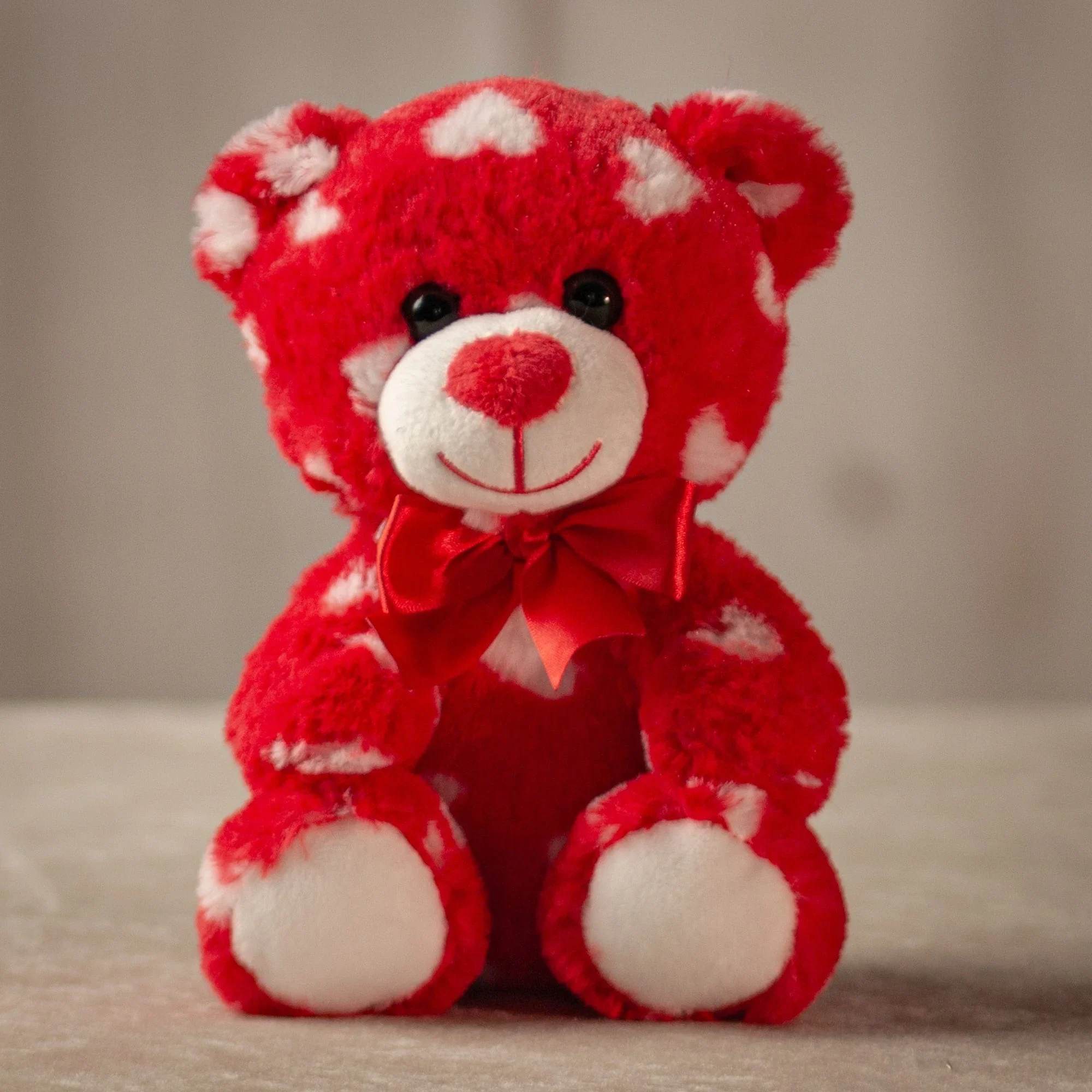 7.5" Heart Print Bear Red - This vibrant Valentine's Day plush set features an adorable teddy bear covered in heart patterns. Each bear is adorned with a matching satin bow, making them perfect for sharing love and affection. These soft and cuddly bears are ideal gifts for Valentine's Day or to brighten someone's day with a heartfelt touch.