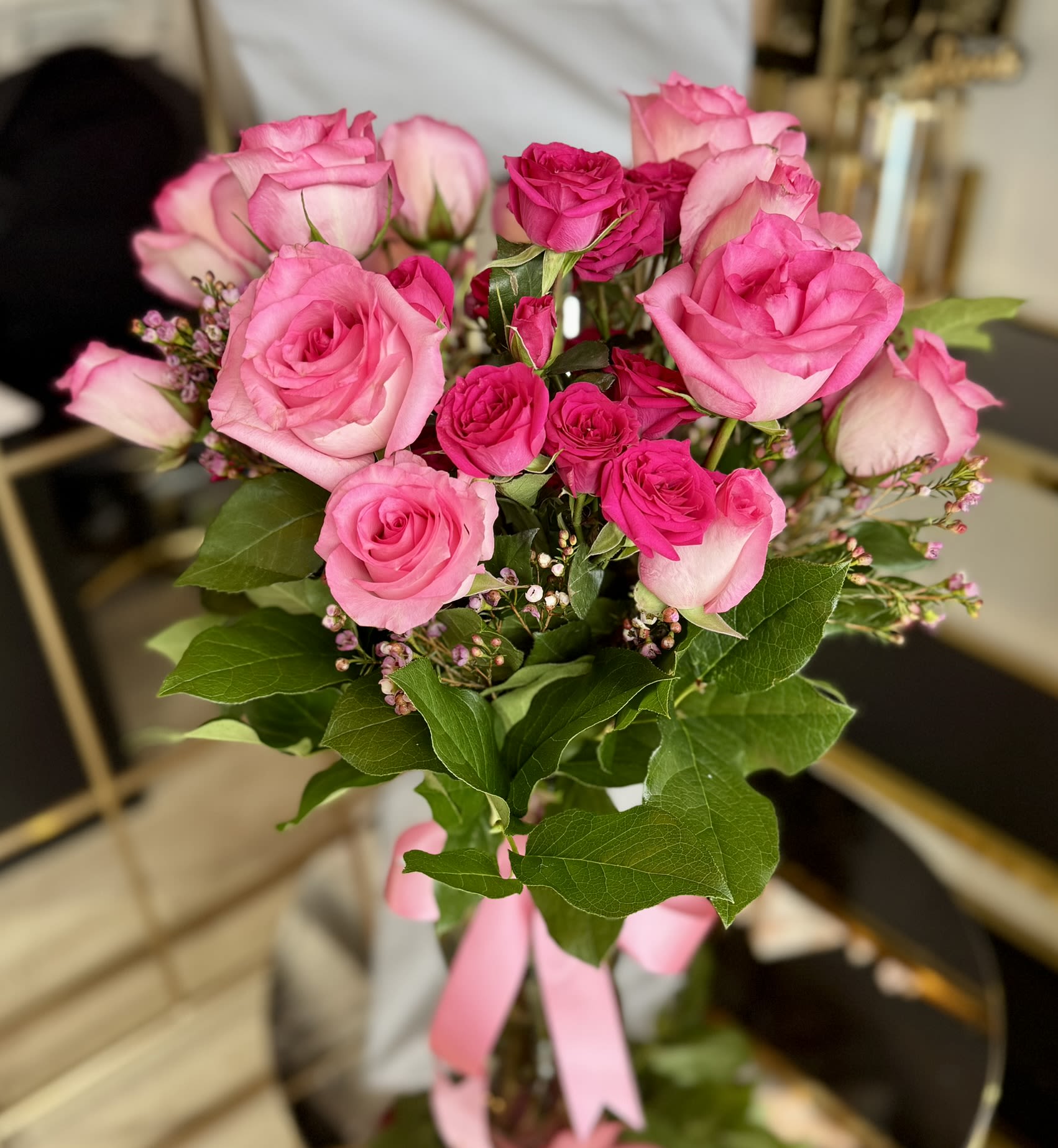 Pink Passion Vase Arrangement  - A vibrant and romantic arrangement featuring a stunning mix of soft pink and hot pink spray roses, accented with fresh seasonal greenery and delicate filler flowers. Designed in a clear glass vase, Pink Passion is the perfect way to celebrate love, joy, and unforgettable moments. Ideal for Valentine’s Day, anniversaries, birthdays, or just because.  Includes Twelve Roses + Spray Roses 