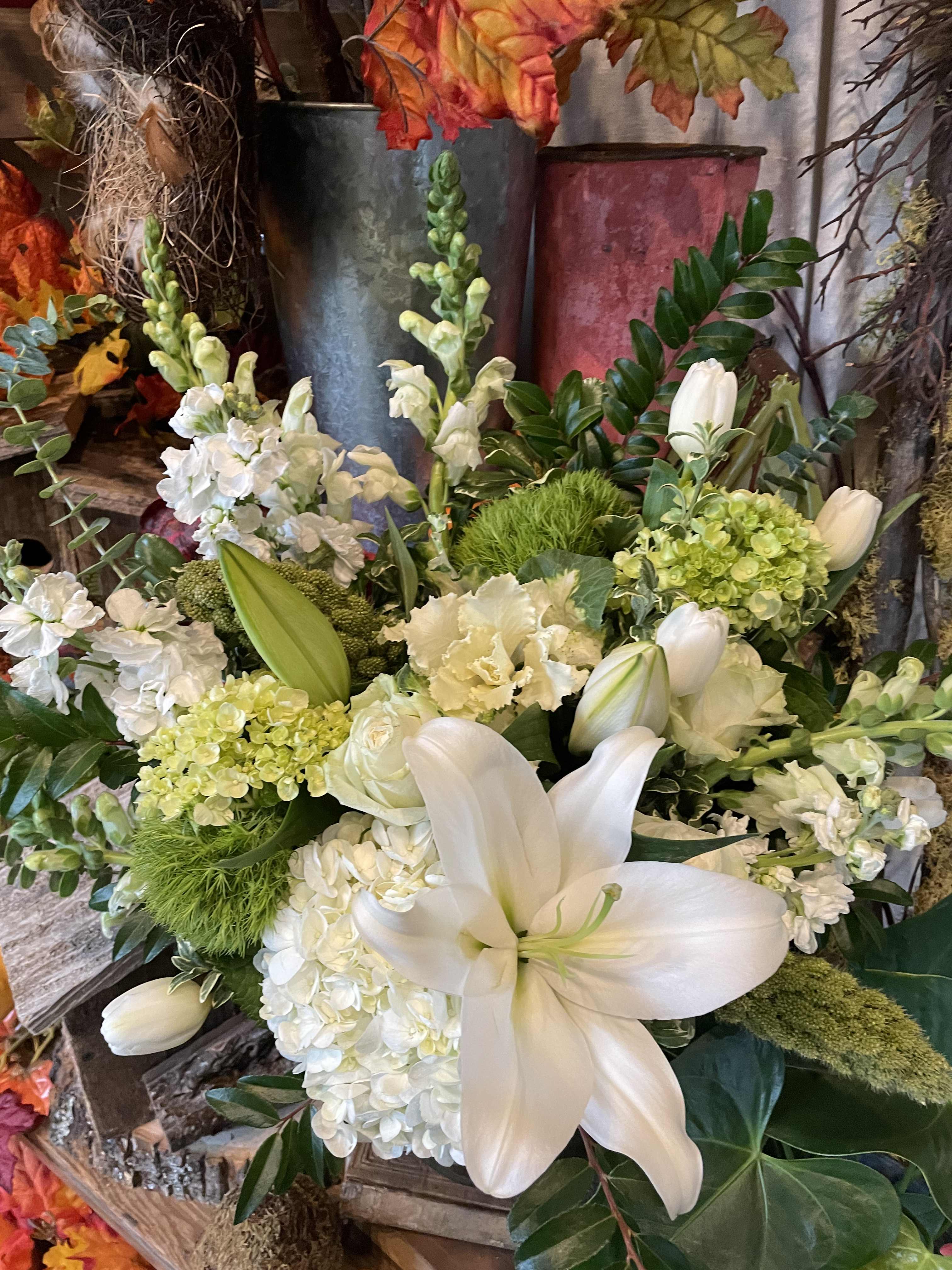 New Growth Green - An elegant arrangement in Greens and Whites.  * Please note that the photo is an example. We design with the freshest and finest blooms in the cooler. Arrangement will stay in the color palette of white and green and maintain the same feel as the example shown.