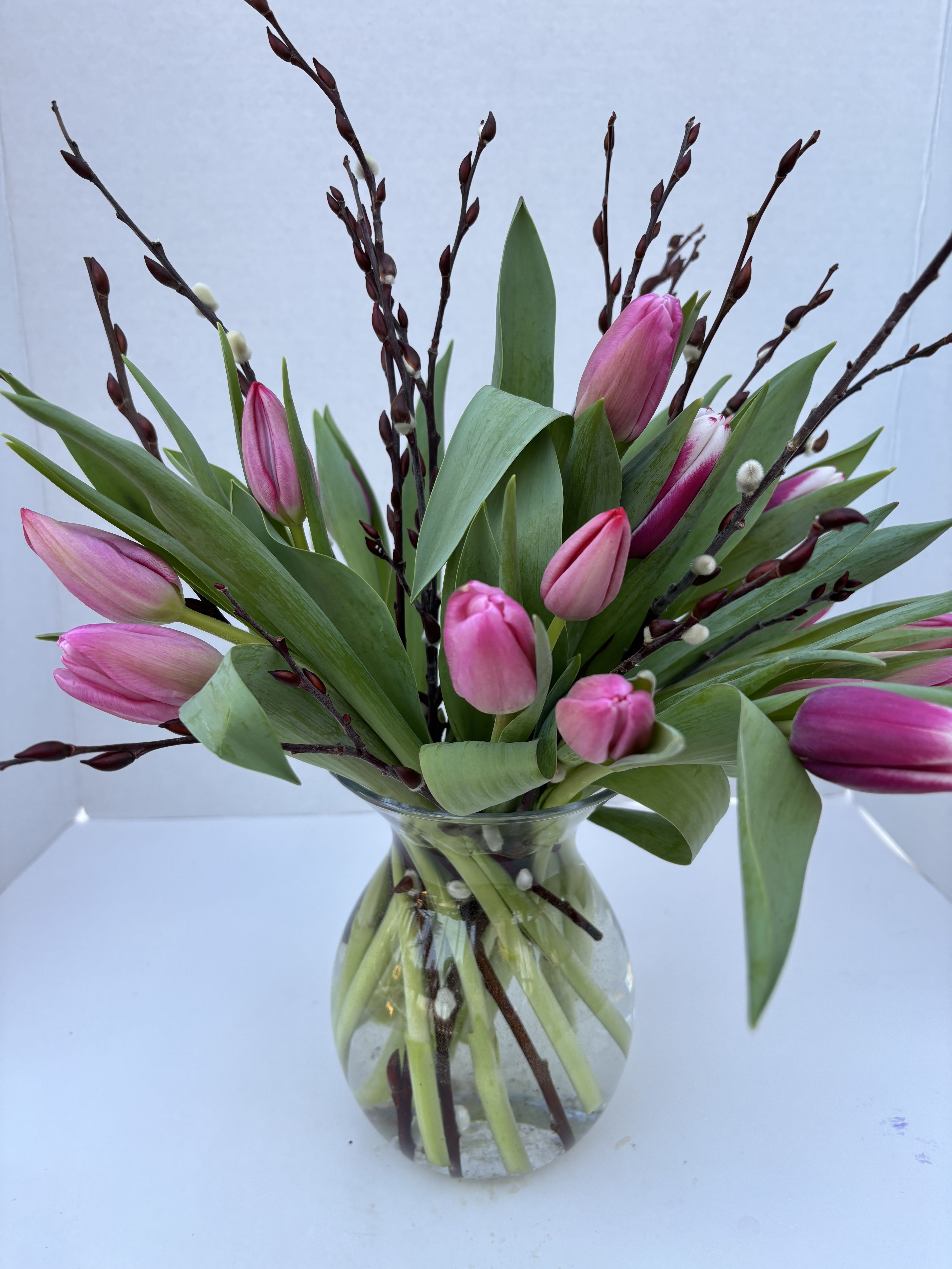 True Love Tulips - shades of lavender and pink tulips show that your heart's in the right place.  A clear vase with catkins  accent complete the look.