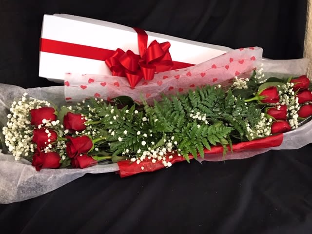 Dozen Rose Box - A beautiful traditional box of long stem red roses with babys breath and greens to create the perfect vase arrangement. Vase not included. 