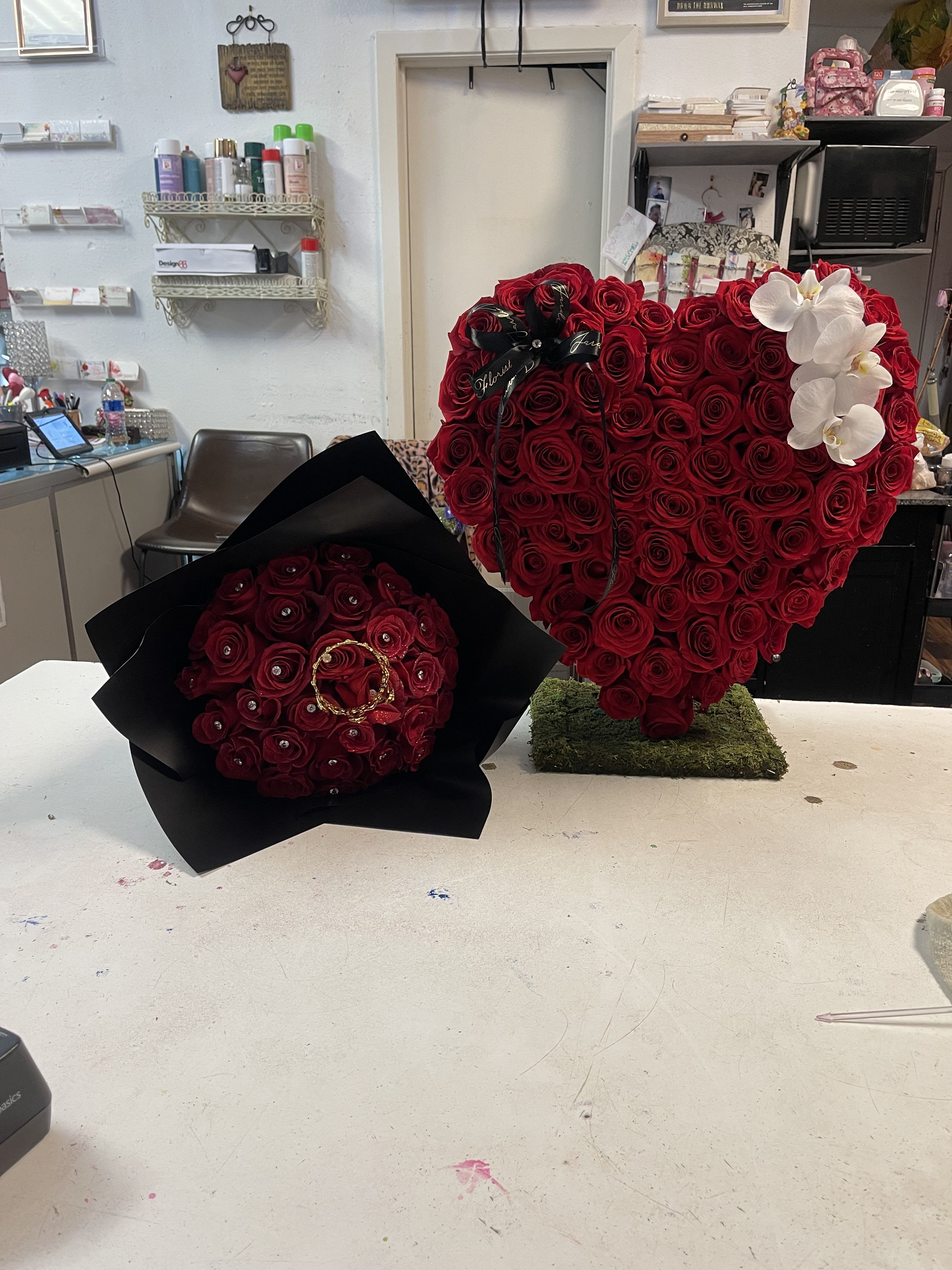 The Forever Love Heart and queen Bling combo  - This combo is a great deal our standing heart is filled with red roses and paired with white orchids and this combo comes with our 30 long stem rose bouquet arranged with diamonds in each rose and a crown. 