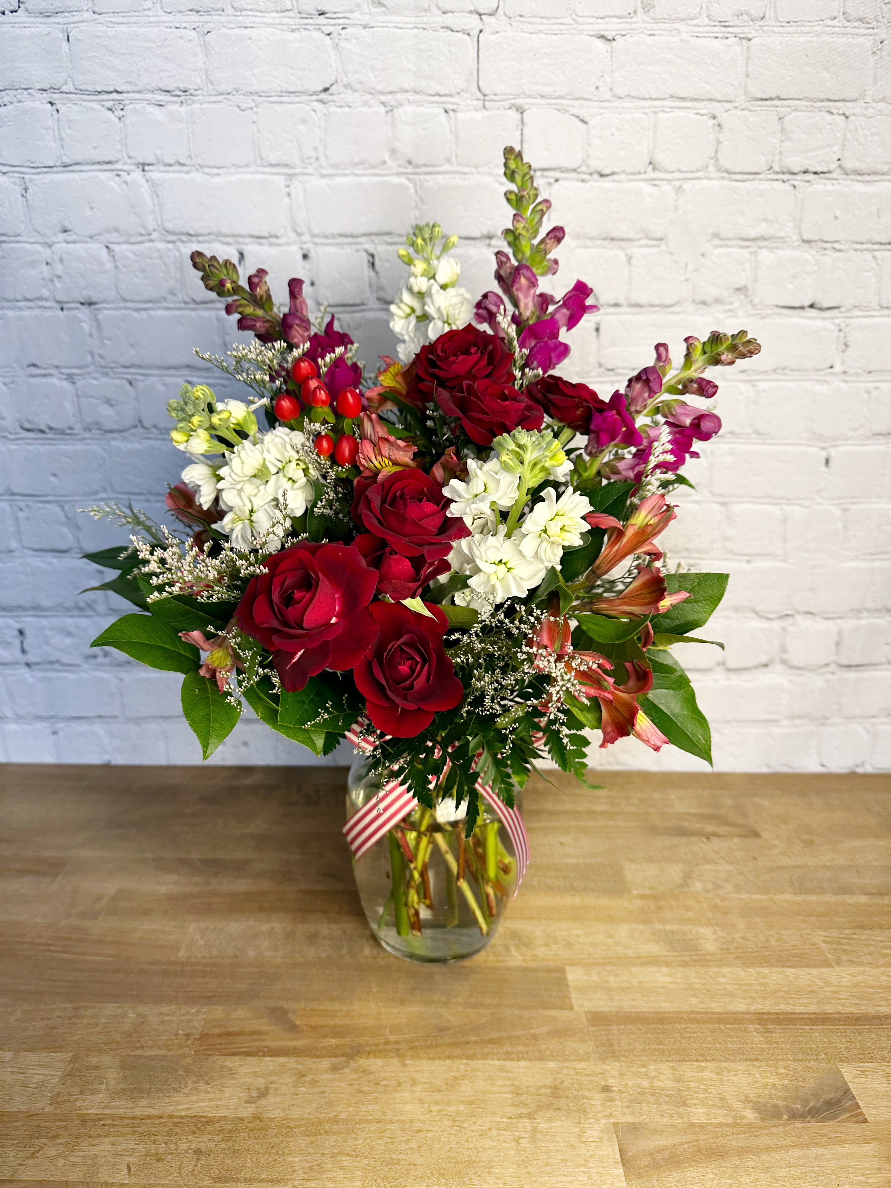You &amp; Me - This beautiful one-sided arrangement has all the colors of the Valentine's day holiday! Includes spray roses, stock, alstroemeria, and snapdragons.   PLEASE NOTE:  Colors may be substituted, but the design and Valentine's day feel will be the same.