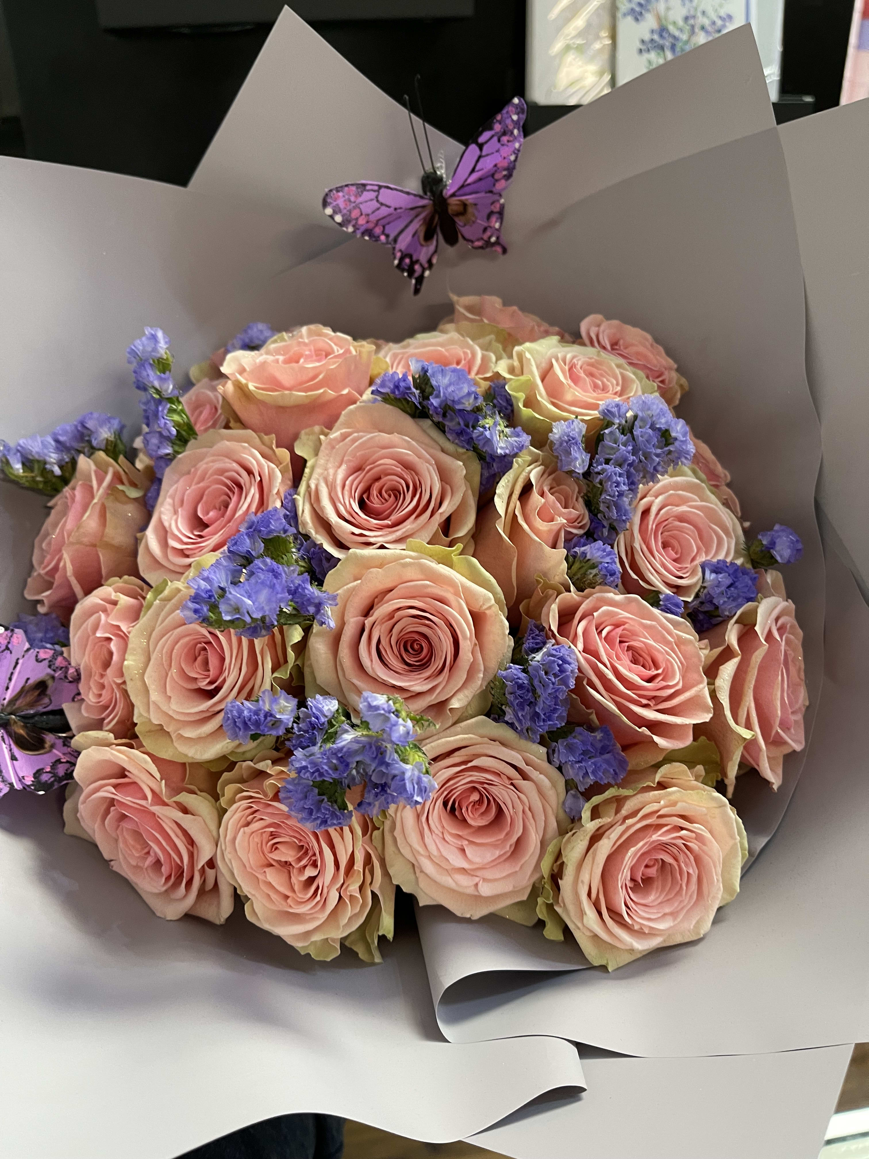 The sensation 24 rose Korean wrap bouquet  - 24 roses in the color of your choice paired with filler flowers to match the color of the roses and carefully wrapped in beautiful Korean wrap paper 