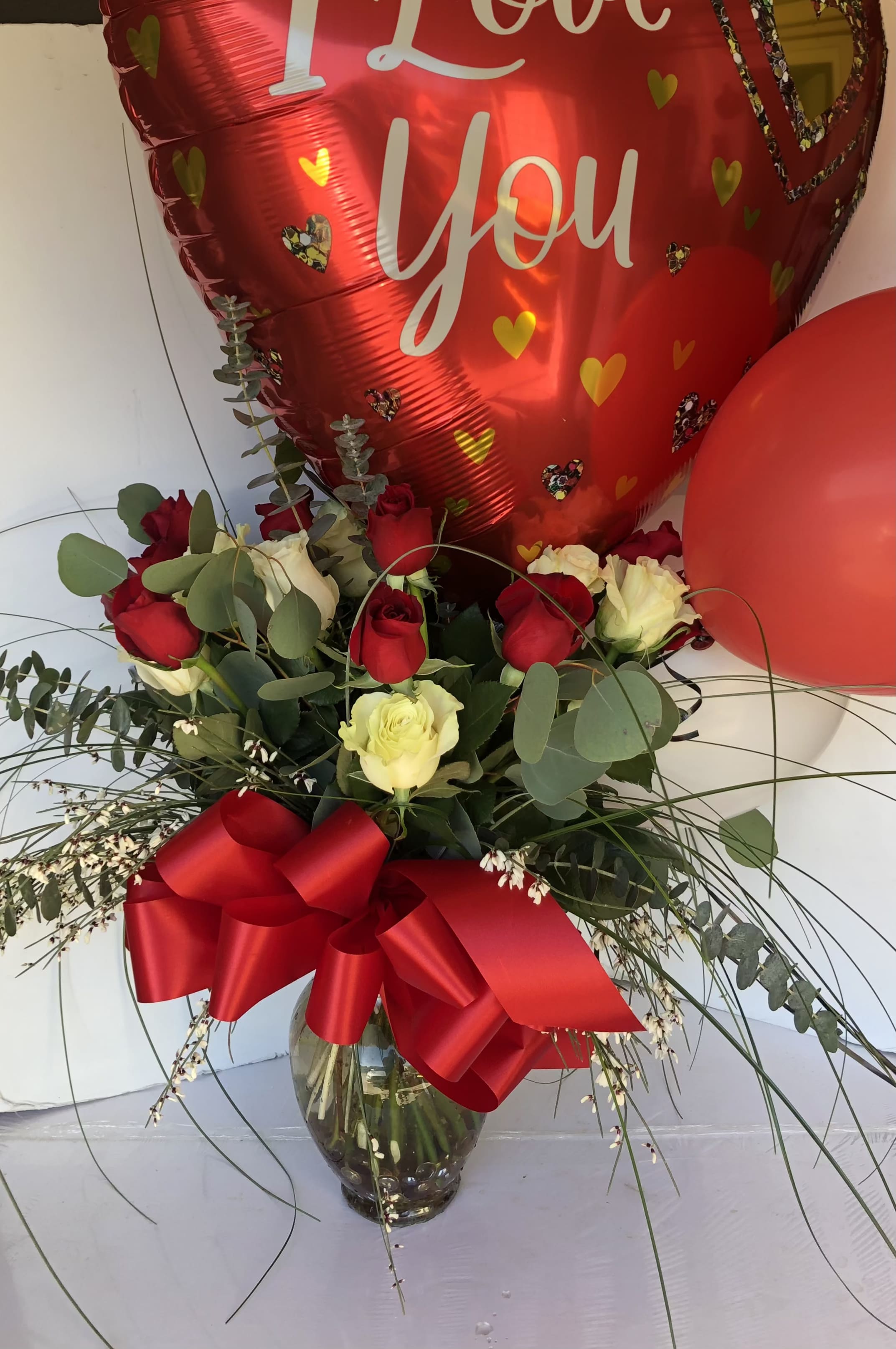 LOVE N BALLOONS - 6 RED AND 6 WHITE ROSES, GREENS AND FILLER WITH A VALENTINES BALLOON
