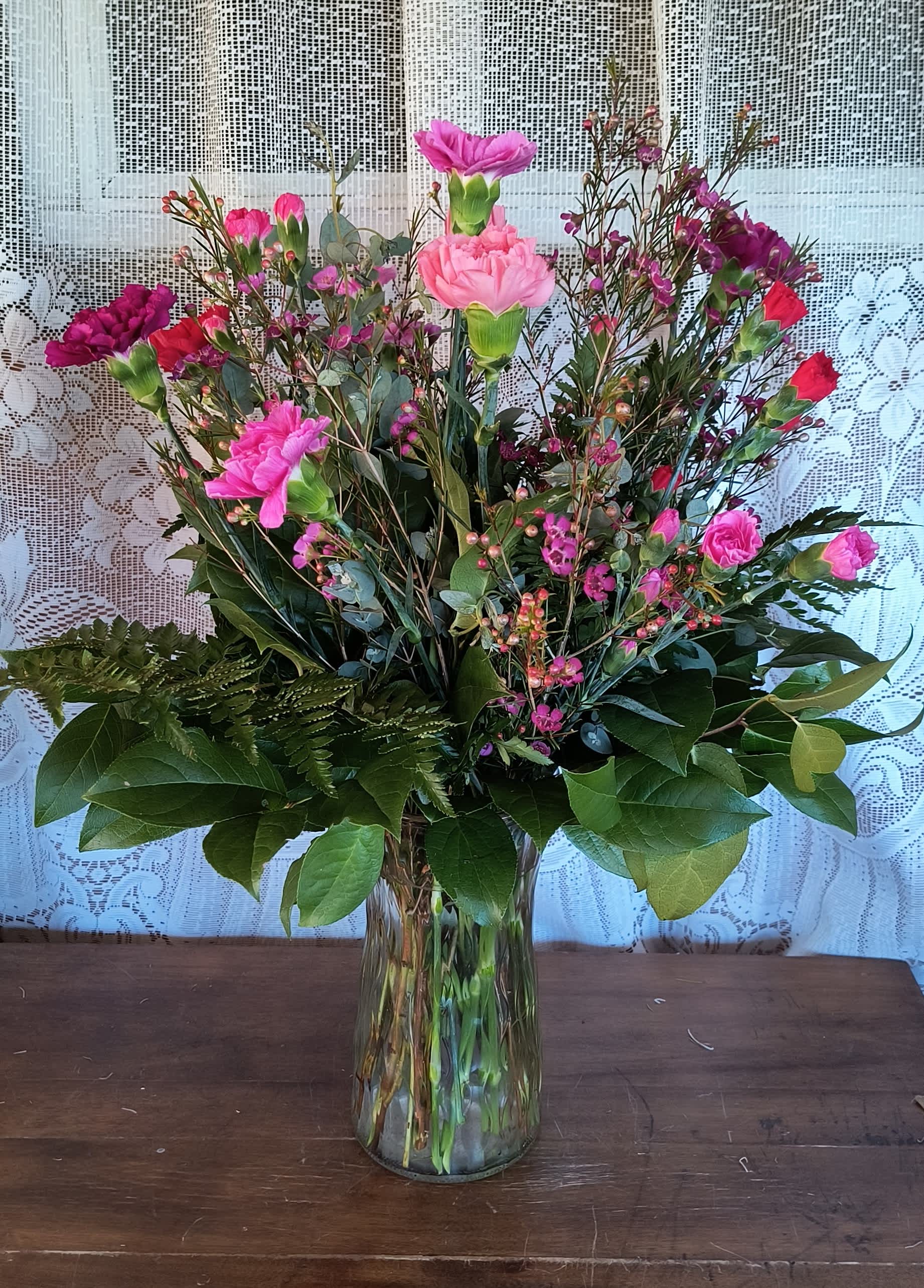 Hugs - Traditional and classic carnations in a designers choice of feminie colors. A long lasting gift.