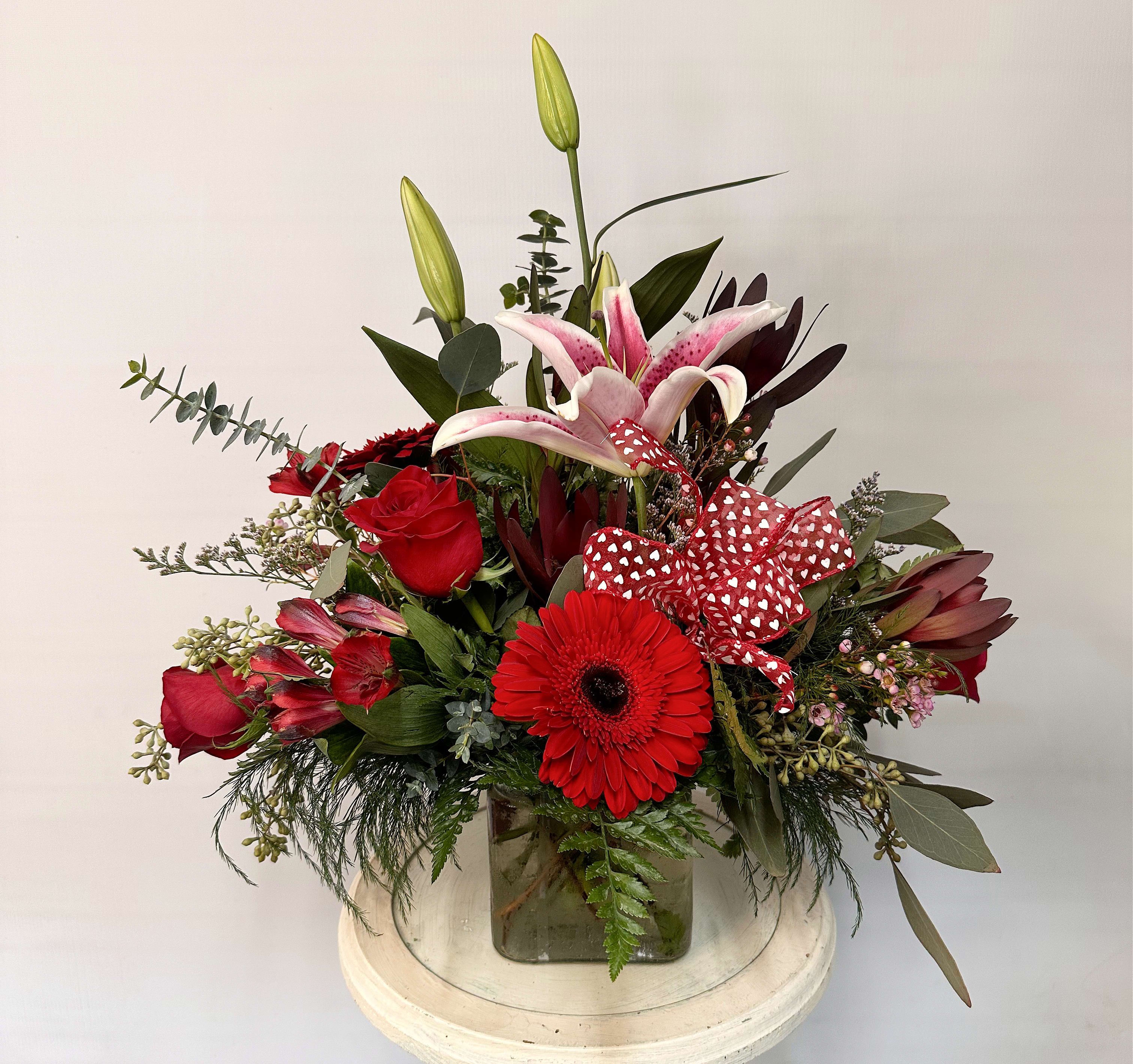 My Love - A stunning mix of Roses, Gerber's, Safari Sunset, Stargazer Lily, Alstroemeria and Caspia.  Arrangement comes in 5" Red Cube. While supplies last. Flowers and containers are subject to substitution.